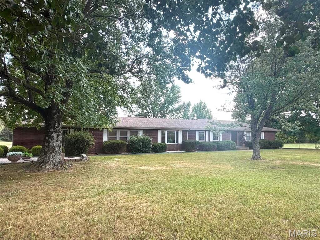 THIS BRICK , FOUR BEDROOM HOME,  IS OVER 4000 SQUARE FEET, LESS THAN TWO MILES OUT  OF TOWN AND ON 7.5 BEAUTIFUL ACRES WITH A LARGE POND.
THIS IMMACULATE HOME HAS TWO LIVING AREAS,  ONE IS FORMAL AND ONE IS A LARGE FAMILY ROOM WITH A WOODBURNING FIREPLACE.
THE KITCHEN IS LARGE WITH MANY CUSTOM CABINETS AND GREAT CERAMIC TILE  FLOOR LAID IN A STYLISH PATTERN.  THE FORMAL DINING  PROVIDES A GREAT PLACE FOR FAMILY GATHERINGS, AND HOLIDAYS.    THERE ARE  THREE BEDROOMS ON THE MAIN FLOOR,  ALL HAVE GREAT CLOSETS.   THE MASTER SUITE NOT ONLY HAS A CEDAR LINED LARGE WALKIN CLOSET,  BUT ALSO A LARGE MASTER BATH WITH DOUBLE VANITY,  SEPARATE SHOWER, AND A LARGE JETTED TUB.  THE BASEMENT HAS A LARGE RECREATION ROOM, GREAT FOR HOLIDAYS WITH THE FAMILY, AND A BEDROOM AND BATH, AND LOTS OF GREAT STORAGE!   OUTSIDE ON THE 7.5 ACRES YOU WILL FIND A THREE CAR DETACHED GARAGE, TWO MORE  METAL STORAGE BUILDING, AND A GREAT POLE BARN.   THERE IS A LARGE POND FOR FISHING OR FOR WATER FOR YOUR HORSES OR CATTLE.   THE DRIVE INTO THE PROPERTY IS BEAUTIFUL IT IS  CONCRETE LINED WITH TREES .  THIS HOME IS NEAR CHURCHES, LEBANON'S GOLF COURSE, AND DOLLAR GENERAL!   LESS THAN TWO MILES OUT OF TOWN!  THIS ONE WON'T LAST LONG. IF YOU ARE LOOKING FOR YOUR NEXT HOME,  BETTER CALL TODAY!