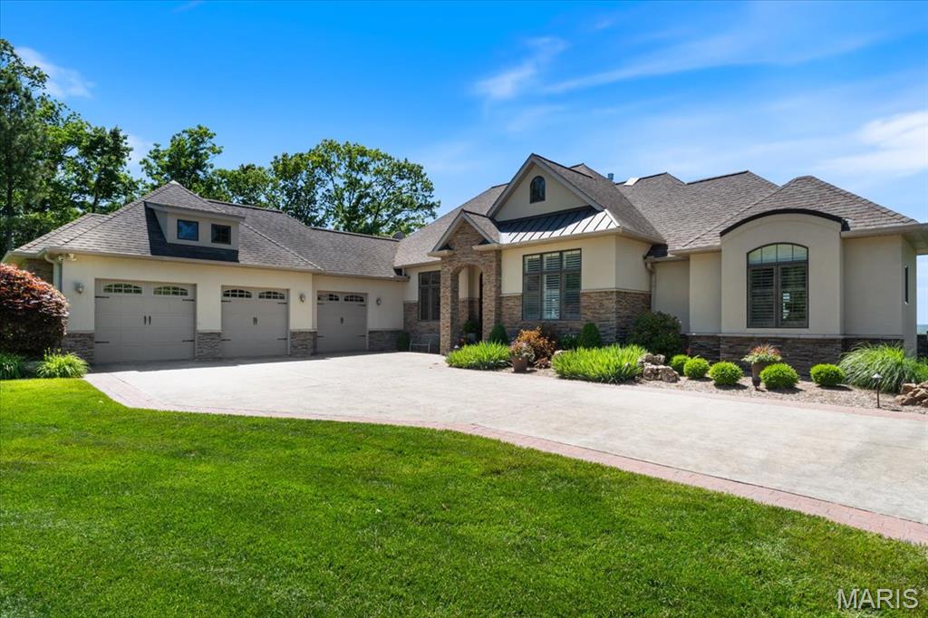 Experience luxury & serenity on this 10 acre gated estate perched atop Eagle Cliff. Impressive Craftsman style home offers panoramic views of the valley below & Missouri bluffs. Plenty of space for entertaining from the outdoor kitchen, infinity pool surrounded by Travertine tiles w/custom designed patio or the deck that spans across the back of the house. Make your way inside to find warm Birch wood floors, views from almost every room, formal dining rm, gourmet kitchen w/2 islands, custom cabinetry, quartz counters, high end appliances & prep sink. Primary suite w/2 walk-in closets, see thru fireplace, luxury bath w/heated floors, walk-in shower w/dual shower/rain heads & heated, jetted tub.Walk-out lower level w/addtl 2 beds, 2 full bath, fully equipped gym w/sauna, family rm w/custom bar & rec rm. Other features include: security system, zoned HVAC & irrigation system & minutes to the JB Bridge. Once in A Lifetime Opportunity to own one of Monroe County's most Premier Estate Homes!