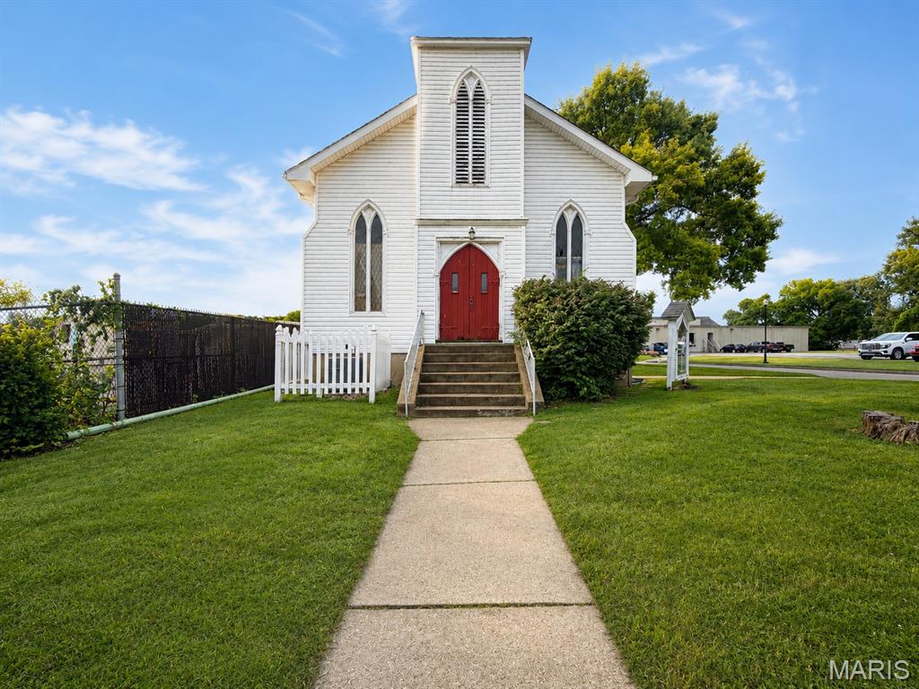 A Rare Piece of Fenton History! For the first time in over 60 years, this iconic landmark in Olde Town Fenton is ready for its next chapter. Originally constructed in the early 1900's, the property radiates historic character, featuring soaring high ceilings, gorgeous traditional wooden pews, wooden trim, a baptismal with custom painted mural, and a beautiful, timeless steeple that anchors its classic silhouette. The building offers a highly functional layout with a full basement and two bathrooms, providing an excellent foundation for continued use as a place of worship, or this highly versatile property opens up endless possibilities—perfect for a growing congregation, an educational facility, professional offices, or a unique residential project. Bring your vision to this Fenton landmark! 
Property is being sold in its current "as-is" condition. Don't miss the chance to own a true community treasure!