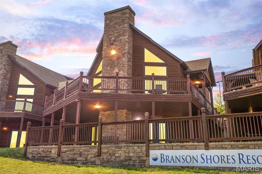 UNBEATABLE LOCATION • UNFORGETTABLE VIEWS • UNMATCHED OPPORTUNITY!
Welcome to one of the most sought-after lakefront properties on Table Rock Lake! This masterfully built 6 BR, 3 BA rustic cabin is tucked into Branson Shores on scenic Stormy Point—just 4 miles from Silver Dollar City and 3.5 miles from the heart of Branson. Inside, warm wood finishes and spacious living areas make it feel like a true mountain lodge. Outside, the lake steals the show with panoramic views, gentle Ozark slopes, and direct access to everything from fishing and boating to cliff jumping and hiking. Resort-style amenities include a zero-entry pool, sand volleyball, firepits, and more. Fully furnished and turnkey—stay as often as you like or rent it out for incredible income. This is lake life at its absolute finest!