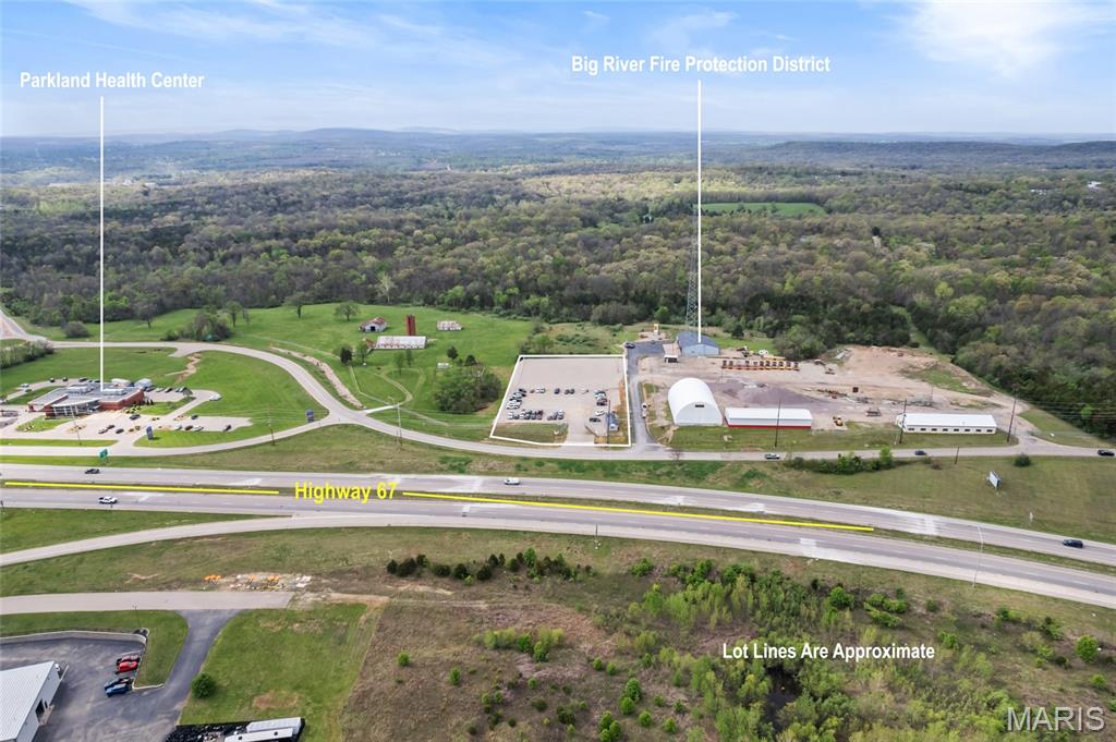 Great owner user opportunity with income in place. This parcel would be great for an owner user that needed space for parking of vehicles and Implements. Front off of parcel is occupied by tenant producing $24,000 a year in income. Front parcel has office with bathroom on site. Back parcel is cross fenced for privacy and owner user. Current owner has recently invested nearly $200,000 of rock,fencing,clearing and lighting to bring parcel to current state. Parcel has been connected to public sewer and water Easy access and Visibility off Hwy 67.