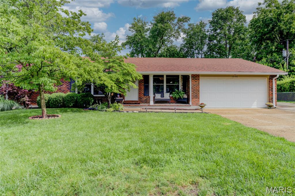 Nestled on a spectacular million-dollar cul-de-sac lot backing to mature trees, this beautifully updated ranch offers the perfect blend of privacy, convenience, and luxurious living. With 2,900 sq. ft. of finished living space, including a walk-out lower level, this home is ideally located with excellent access to shopping, dining, major roads, highways, medical facilities and Creve Coeur Lake. The impressive exterior features low-maintenance brick construction, attractive landscaping, cozy covered front porch, updated wood deck and charming firepit area. Inside, you'll find beautiful wood floors, neutral decor, crown molding, updated lighting, thermal windows, and a welcoming wood-burning fireplace. Numerous major improvements provide peace of mind, including roof, furnace, A/C, water heater, electrical panel, plumbing updates, front entry door, blinds, insulated garage door, carpet and renovated bathrooms. The chef-inspired kitchen is designed for both everyday living and entertaining, showcasing granite countertops with undermount sink, breakfast bar seating, stylish tile backsplash, stainless steel appliances, newer dishwasher and a 5-burner gas range. Bonus main floor laundry room w/utility sink. The open and functional layout flows seamlessly into the living and dining spaces, while the finished walk-out lower level provides abundant additional living, recreation or guest space. Rarely does a property combine such a premium lot and setting, extensive updates, generous living space, pampered condition and  exceptionally convenient location. Enjoy peaceful views, outdoor gathering spaces, and move-in-ready condition in a setting that truly feels like a private retreat while remaining close to amenities.