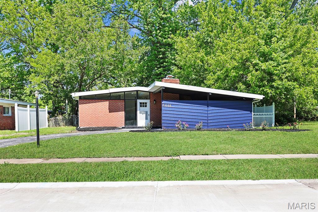 Introducing 8445 Bayberry Drive, a fully renovated mid-century modern ranch that blends timeless architecture with today's most sought-after finishes. Vaulted ceilings, a striking brick accent wall, and a wood-burning fireplace create a dramatic living space filled with natural light. Double sliding doors open to a private patio, seamlessly connecting indoor and outdoor living. The stylish kitchen features crisp white cabinetry, stainless steel appliances, and elegant gold plumbing fixtures. A second brick accent wall adds warmth and character to the dining area. The spacious primary suite offers a private full bath and double closets, while two additional bedrooms provide flexibility for family, guests, or a home office. Additional highlights include first-floor laundry, black lighting and electrical fixtures, bright white walls, a fenced backyard, and a covered carport. If you appreciate clean lines, natural light, and thoughtful design, this mid-century modern gem is not to be missed.