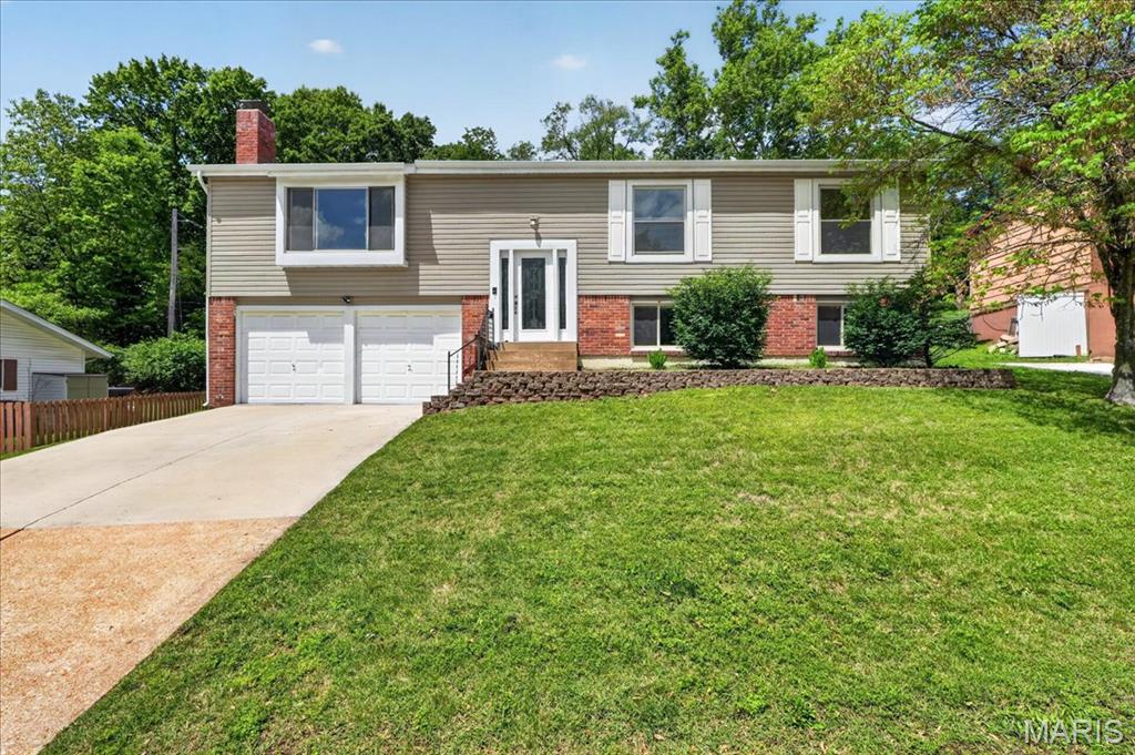 OPEN HOUSE SUNDAY MAY 10 FROM 1-3 PM. Brick & vinyl sided split foyer with an architectural shingle roof. This spacious 4br, 3 full bath home provides 1484 sq ft on the main level and another 325 sq ft on the lower level with egress windows. The interior has been newly painted, there is a new ceramic tile floor in the kitchen and new luxury vinyl plank flooring in the lower level. There are new vanities in both bathroom on the main level along with new glass shower doors in the primary bath. Upon entering the main level you can't help but discover soaring vaulted ceilings in the living room, dining room and kitchen. The main level is mostly wood floors(no carpets anywhere), white 6 panel doors and double pane vinyl insulated windows. There is a sliding glass door off of the kitchen and one off of the primary bedroom, both leading to patios. The kitchen has white 42" cabinets and hard surface counter tops and include all stainless steel appliances. Both main floor baths are updated beyond just new vanities. In the lower level you have 2 rooms connected to one another that might be ideal living space for a child or family member because it would provide a social gathering area and a bedroom with a full bath and a spacious walk-in closet. The 2-c garage is oversized with the left side bay running 28 ft deep.