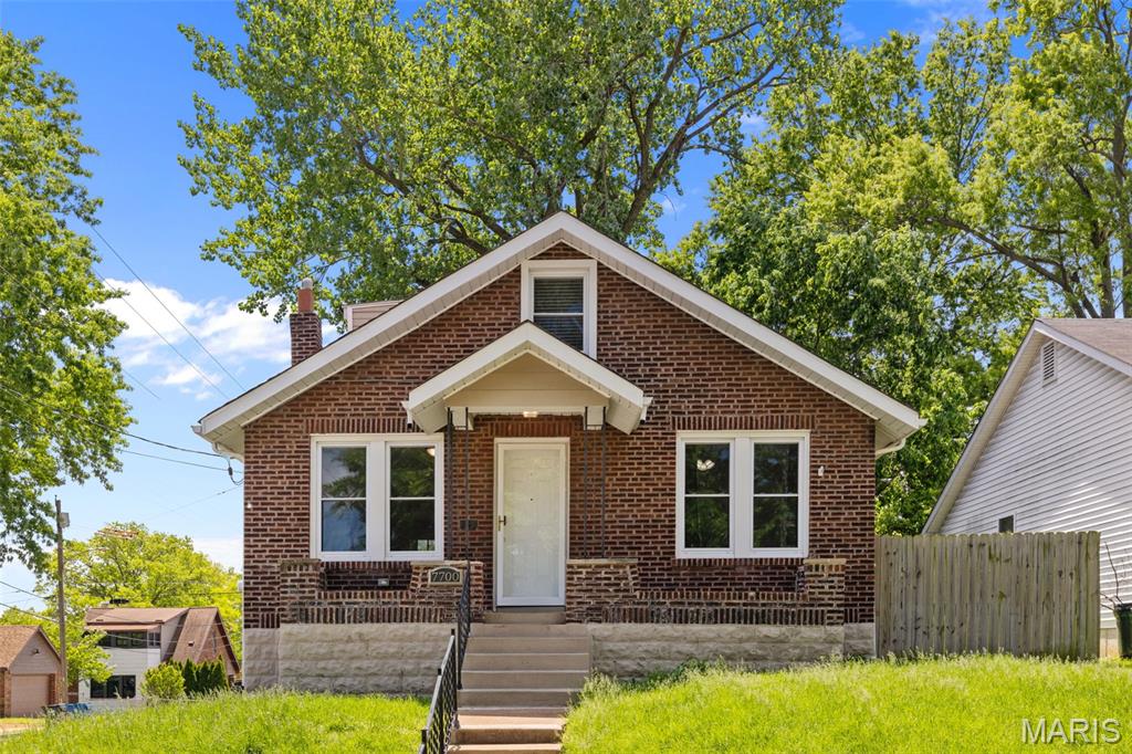 Welcome to this charming and updated brick 1.5 story in a wonderful Richmond Heights location! You'll have great curb appeal with a brick and stone exterior and covered front porch leading you inside. The layout of the living room, dining room and kitchen is perfect for hosting gatherings and for everyday living. It's a thoughtful blend of old-world detail and modern convenience: gleaming hardwood floors, millwork, archways, classic glass doorknobs, and beamed ceiling, plus granite counters, 42" white shaker cabinets, a tile backsplash, stainless steel appliances, and stylish light fixtures. The bathroom features an arched, tiled tub surround, pedestal sink, and wood-look tile flooring. Two spacious bedrooms complete the main level. Upstairs is a flex space - bedroom or playroom and sitting room, den, or office - ready to make your own! A partially finished basement and tuck-under garage provide plenty of space for storage. Enjoy the spring weather on the patio overlooking the fenced backyard shaded by trees. You'll be walking distance from Richmond Heights community center and library, and moments from shopping, schools, parks, and highways, as well as Downtown Clayton. Don't miss out on this one!