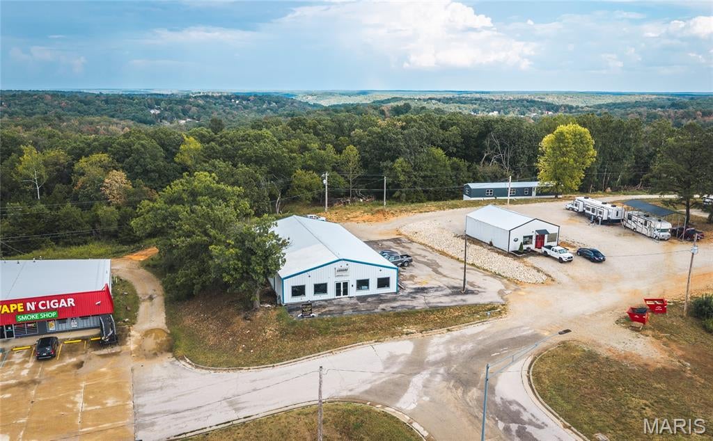 A little over half an acre with a commercial 90x50 shop and just 2 miles from the front gate of Ft. Leonard Wood! This property is currently functioning as an HVAC shop and has great potential for a new business. Property has a well and is located in the county. High traffic count being just off of I-44 that generates anywhere from 20,000-25,000 vehicles passing per day. Property has 2 RV hookups behind the building to potentially generate income as well! Property address was recently changed so address will not take you to property. Please us 996 Missouri Ave. for GPS purposes.