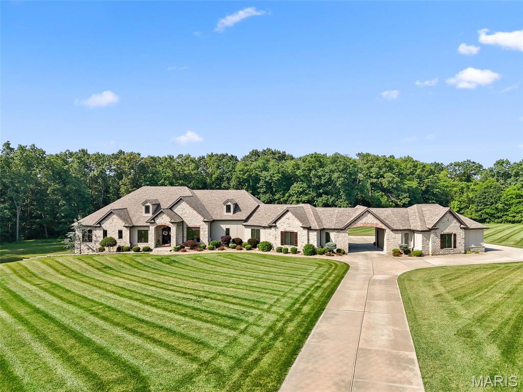 Simply amazing!  So much thought and care went into the design and build of this home... I would not change a thing! 7+ acres of privacy and nature complete with trails and a creek! The perfect backyard with a saltwater pool that does not disappoint! Entertain under the incredibly spacious covered back patio with built in fireplace, surround sound and more!  The kitchen will "wow" the cook in the family and the 6+ garage spaces will satisfy any car enthusiast! Huge primary/. suite with a giant walk in closet connected to laundry room.  Primary bath has an incredible shower and a private door to the hot tub on the extremely private back patio.  Amazing attention to detail and quality! This is one of those rare properties that comes along once in your life! Public sewer and water and Natural Gas!  No septic or well to deal with! Geo-Thermal HVAC system and countless other upgrades. Come and see your Trophy Home today!