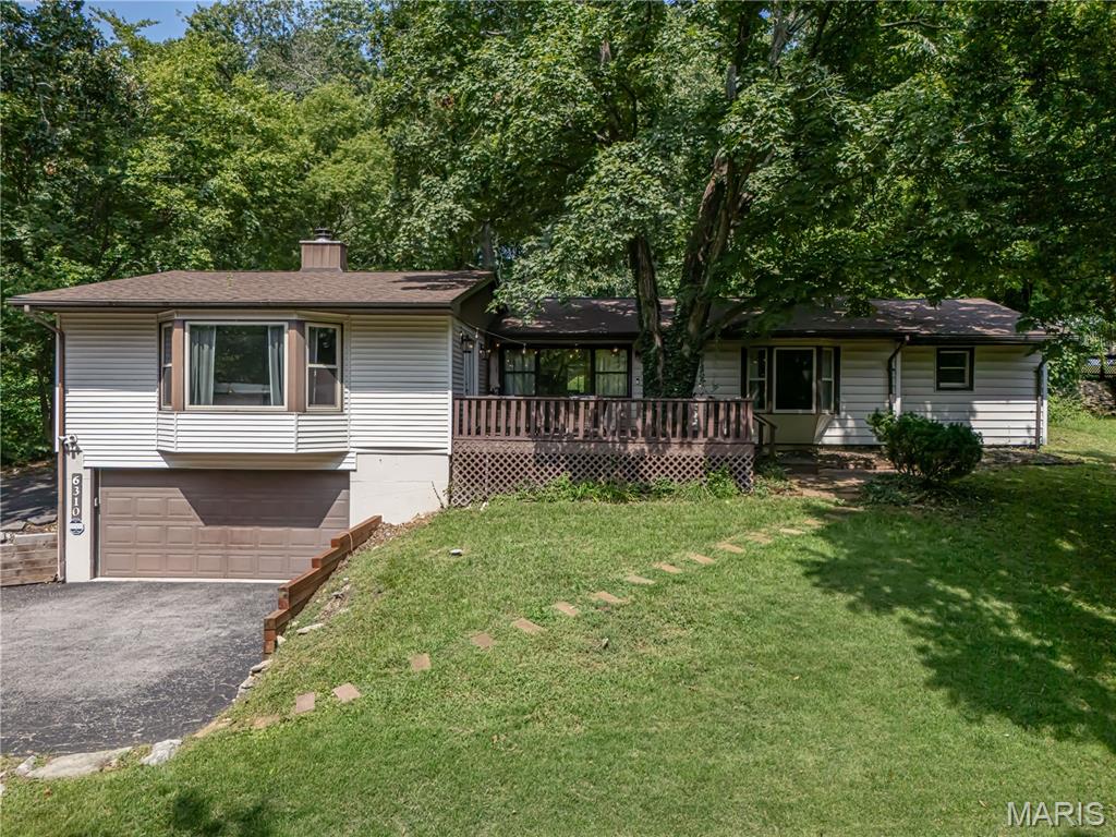 Tucked away on nearly half an acre of mature trees, this beautifully renovated raised ranch offers a rare blend of privacy, nature, and modern comfort—all while remaining minutes from everything South County has to offer. Surrounded by peaceful wooded views, the home features expansive picture windows, multiple outdoor entertaining spaces, and an enclosed patio that creates a true retreat-like setting rarely found in such a convenient location. Inside, the open concept layout seamlessly connects the living, dining, and kitchen areas, showcasing updated finishes, butcher block countertops, stainless steel appliances, luxury vinyl plank flooring, and stylish designer touches throughout. The spacious family room with its beamed ceiling and cozy gas fireplace provides the perfect gathering space, while the generously sized primary suite and updated baths offer everyday comfort. Beyond the property, enjoy quick access to some of South St. Louis County's most popular destinations. Spend weekends hiking, biking, fishing, or enjoying scenic overlooks at Cliff Cave County Park and Bee Tree County Park, both known for their beautiful trails, picnic areas, and Mississippi River views. Shopping, dining, and everyday conveniences are just minutes away along Telegraph Road.  This home delivers the perfect combination of peaceful living, exceptional convenience, and a setting that truly feels like a hidden escape.  If you've been searching for a property that offers character, privacy, and a connection to nature without sacrificing accessibility, this is an opportunity you won't want to miss.