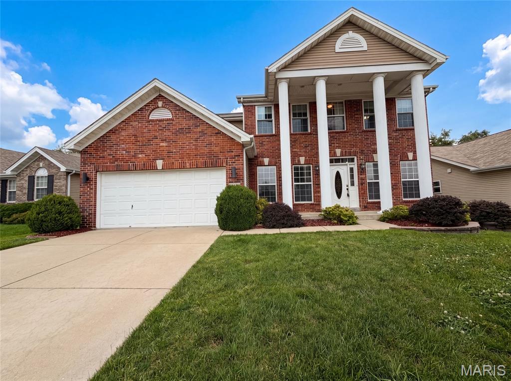 819 Harding St, Saint Peters, MO 63376 is a two-story Saint Peters brick single- home built in 2010 with four bedrooms and a finished basement that adds flexible living space. The kitchen combines white cabinetry, a center island, granite countertops, a tile backsplash, and stainless steel appliances over hardwood floors, opening to a living area where a fireplace anchors the room, adding warmth and a defined gathering point. The primary bedroom connects to a bathroom with a double-sink vanity for shared morning routines, a soaking tub, and a separate glass-enclosed shower, while a walk-in closet keeps clothing organized. Additional full bathrooms serve the upper level and the basement, where a rec room with a stacked-stone fireplace wall and a wet bar extends entertaining space. An attached two-car garage completes this well-maintained residence with practical amenities throughout every room.. Included 100-Day Home Warranty with buyer activation
