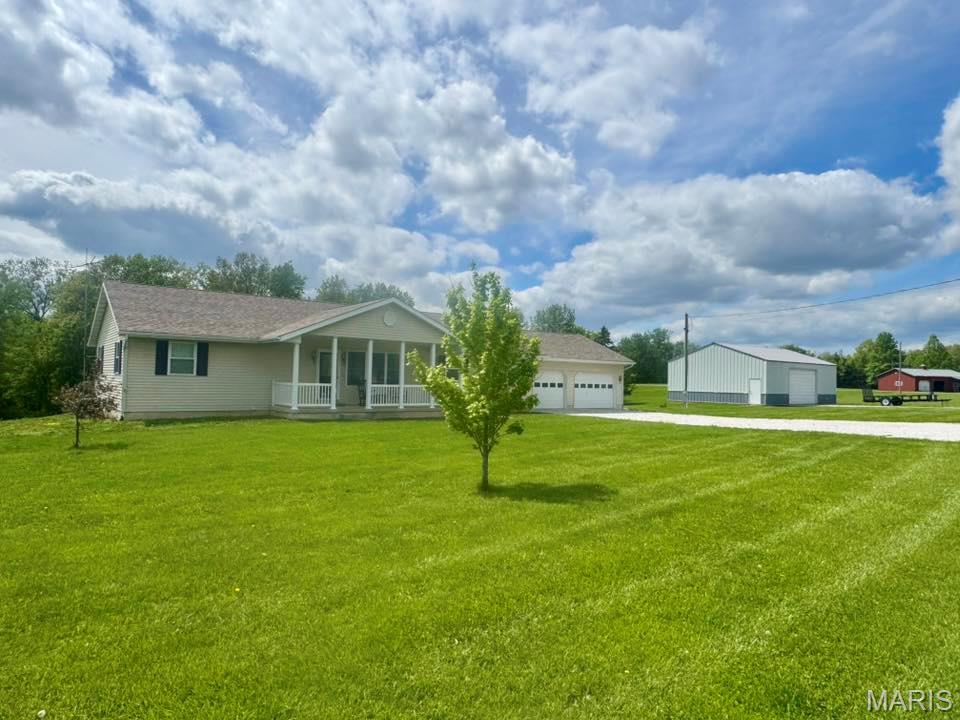 Check out this 4-bed, 3-bath home sitting on 2.5 acres just outside of Monroe City near the Mark Twain Lake that truly checks all of the boxes! The main level conveys an open concept living area with bamboo flooring which flows into the kitchen complete with an island, separate dining area and sliding glass doors to walk out onto your deck to see the incredible back yard views. A massive primary bedroom & bathroom ensuite with a walk-in tile shower complete the upstairs; walk downstairs to find an additional 1,700+sqft of finished living area including the 4th bedroom & a 5th nonconforming bedroom or office! Outside on the property you will find a large metal shop with power overhead door, concrete patio & basketball hoop, plus acreage to utilize however you please. Whether you stay at home or hit the nearby lake, this property is an in-person must-see!