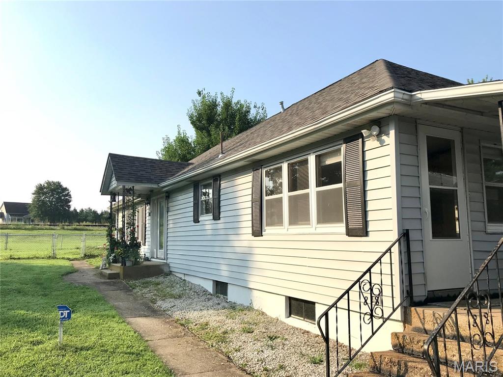 Welcome to this charming 3-bedroom, 2-bath home situated on approximately .92 acres in historic Rosati, Missouri. Conveniently located within walking distance of a local winery and close to  St James and area amenities, this property offers the perfect blend of space, comfort, and small-town living.

Inside, you'll find beautiful real hardwood flooring, a spacious kitchen featuring hickory cabinetry, and an abundance of windows that bring natural light into the home from every angle. The living room offers a cozy gas fireplace, creating a warm and inviting space for relaxing or entertaining. The main bathroom features an oversized walk-in shower for added comfort and convenience.

A covered porch overlooks the beautiful lawn and provides a peaceful place to enjoy the outdoors. The property also includes a chain-link fenced area, storage shed, and a 2-car carport with an attached 1-car garage/workshop and additional storage.

There's plenty of storage throughout the home, plus an unused attic space offering exciting potential for additional living area, office space, hobby space, or storage. With nearly an acre of land, numerous storage options, and room to grow, this property offers a wonderful opportunity to enjoy the character and convenience of historic Rosati.