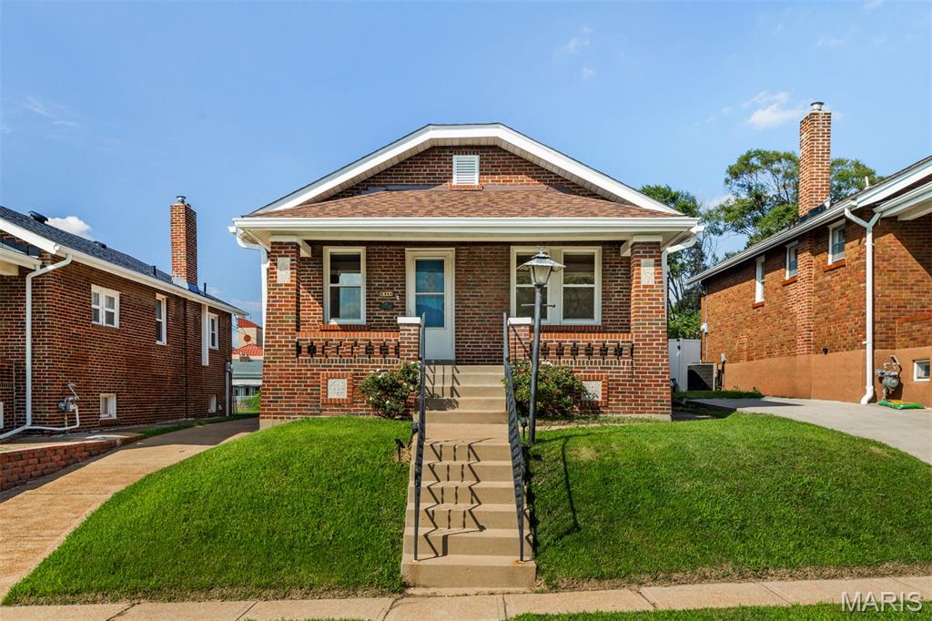 Wonderful brick bungalow featuring 2 bedrooms and 1 bathroom. You are welcomed with a large covered front porch and will feel right at home the second you enter. The spacious living room boasts an ornate front door with stain glass window and arched doorways. There is a separate dining room offering tons of space that could be used an office/den. This room brings in lots of natural light from the surrounding windows including another beautiful stain glass window adding even more character to this home. The eat-in kitchen is complete with newly installed white cabinets, lots of counter space, some stainless-steel appliances and plenty of space to add a center island or table setup. Both bedrooms provide ample space and have large closets for all your storage needs. Bathroom is conveniently located with a single vanity and shower/tub combo. The partially finished walk-out basement is where you will find your laundry area and so much space for storage. Onto the backyard where you will find a large deck perfect for relaxing on a nice day or entertaining guests. The backyard is fenced and leads to the detached 1 car oversize garage with workshop space. Some updates to the home include a new roof, guttering, window wraps, flashing and garage siding in 2025 and a new chimney cap in 2026. This home has so much character throughout with original features including doors, molding and trim. Be sure to check out this charming home today that is located close to desirable restaurants, shopping centers and venues.