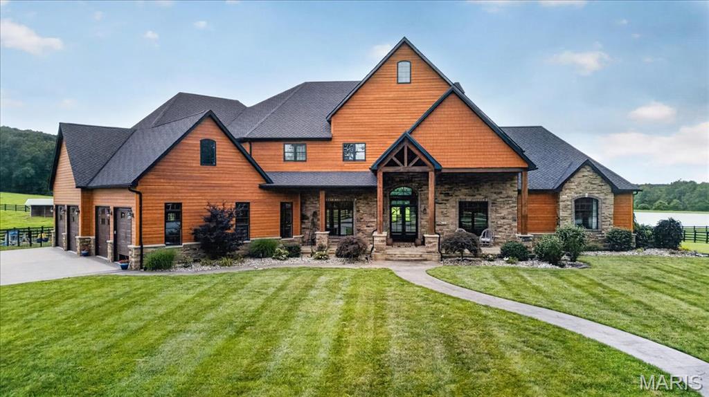 Welcome to Sanctuary Ridge, an impressive equestrian estate located on over 104 acres of panoramic beauty.  As you drive through the gated entrance and down the tree-lined driveway, you will immediately be awed by the magnitude of this property.  The impressive, yet comfortable home features over 10,000 sf of living space, including 5 bedrooms, 7 bathrooms, 40 ft. vaulted great room, commercial grade appliances, Taj Mahal quartzite countertops, and butler’s pantry.  The main floor primary suite includes vaulted wood ceilings, gas fireplace with stone hearth and a bathroom like living in your own spa.  The remainder of the home is just as impressive, with a fully finished lower level with 12 ft foundation, whole home generator and oversized 4 car garage.  Moving on to the equestrian/livestock portion of the estate is an 8 stall horse barn with its own 3 bedroom, 2 bath bunkhouse, which also includes a full kitchen and laundry room.  Next door is a hay barn/equipment shed, then the recently constructed 16,000 sf professional grade indoor riding arena.  There are 5 pastures on the property, each with their own shelter, automatic watering system & iron fencing.  Also on the property sits a 7 acre stocked pond and  the St. Francis River running through the back portion of the property.  The Farmington Regional Airport is only 20 minutes away.  You truly have to see this masterpiece to believe it!