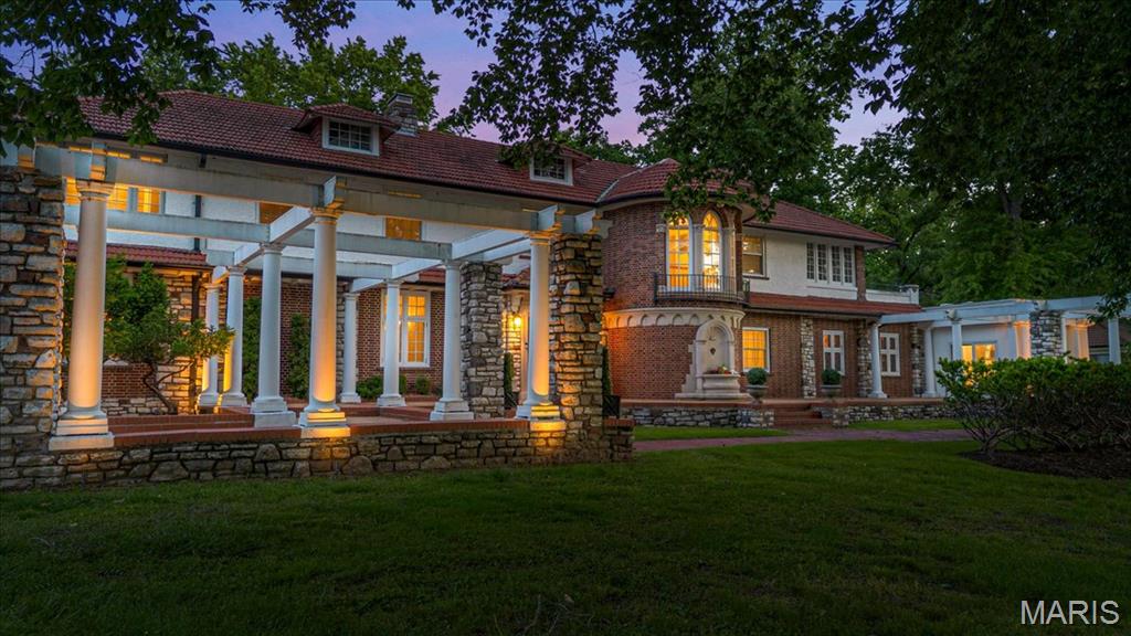 Step into the elegance of 1601 South Warson Road, a breathtaking Spanish Revival estate
gracefully set on 3.32 acres in the heart of Ladue—one of America’s most prestigious communities.
Built in 1926 for Horton Watkins, this landmark residence seamlessly merges timeless European
charm with the refined comforts of modern luxury, following extensive updates completed between
2020 and 2021. Spanning over 7,000 square feet, the estate offers 7 bedrooms, 5 full baths, and
one half bath, including two main-floor suites ideal for guests or multi-generational living. The
exterior exudes classical sophistication with its brick and stucco facade, original arched portico, and
iconic red tile roof that defines the Spanish Revival style. Inside, grand formal rooms showcase
original plaster craftsmanship, inlaid wood floors, and leaded glass windows that fill the home with light.
A chef’s kitchen anchors the heart of the home—featuring granite countertops, professional-grade
stainless steel appliances, and a butler’s pantry designed for seamless entertaining. Two laundry
rooms provide modern convenience across both levels. A graceful spiral staircase leads to the upper
floor and a lavish primary suite, complete with dual full baths, dressing room, and private laundry area.
Multiple sunrooms and garden-view salons open to lush patios and landscaped courtyards, creating an
atmosphere of peace and refinement throughout. Beyond its architectural beauty, this estate holds
deep historical significance. Horton and Ruth Watkins were among Ladue’s most prominent
philanthropists—Ruth donating the land across the street for the creation of Ladue Horton Watkins
High School and co-founding the International Institute of St. Louis, a cornerstone of humanitarian
and educational outreach. Today, Ladue ranks among the Top 10 Cities in the United States for
Quality Living (2025) . Owning 1601 South Warson Road means more than acquiring
a residence—it’s the rare chance to preserve a chapter of St. Louis history while embracing an
incomparable lifestyle of privacy, prestige, and elegance.
This is a duplicate listing MLS #26038831