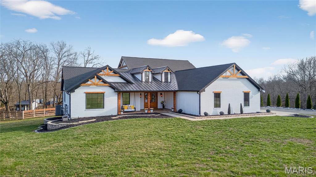 Welcome to your private luxury ranch retreat — a fully custom estate set on 20 unrestricted acres of pristine, huntable land offering total freedom, privacy, and endless possibilities. Spanning approximately 3,000 square feet on the main level, this fully custom ranch masterpiece was designed with bold architectural presence and sophisticated, modern-chic finishes throughout. Clean lines, soaring ceilings, and expansive walls of glass create a striking first impression while flooding the interior with natural light and panoramic views of your private acreage. The open-concept living space is both dramatic and inviting — anchored by a grand living room with statement lighting, designer textures, and seamless indoor-outdoor flow. The gourmet chef’s kitchen is a showpiece, featuring custom cabinetry, premium appliances, oversized island, and refined finishes that blend warmth with contemporary elegance. Every detail has been curated for a luxury lifestyle and effortless entertaining. The main level offers a luxurious primary suite with spa-inspired bath and oversized walk-in closet along with 2 other bedrooms and 2.5 designer bathrooms. Downstairs, the fully finished custom basement expands your living space with incredible versatility. It includes: An additional bedroom and full bath, large secondary living room & recreation space with two storage rooms, a bonus room, an office, a vault room and a security bunker. Whether for preparedness, privacy, or protection, this lower level was designed with intention and functionality in mind. Outside, the property truly shines. The 20 acres are fully usable and unrestricted — ideal for hunting, recreation, livestock, trails, or simply enjoying wide-open space without HOA limitations. Beyond the home, the estate continues to impress. The 20 unrestricted acres provide complete autonomy — hunt, ride, build, expand, or simply enjoy unmatched privacy without HOA limitations or land-use restrictions. Complementing the residence is an impressive 3,000 square foot climate-controlled barn, masterfully converted into a modern barndominium. With heat and air throughout, this structure offers exceptional versatility — from luxury workshop to event space to income-producing opportunity. Attached is a beautifully finished 1-bedroom, 1-bath private apartment, ideal for guests, extended family, ranch staff, or rental income. Bold. Refined. Unrestricted. A rare combination of upscale craftsmanship and unrestricted country living — this is more than a home, it’s a legacy property.