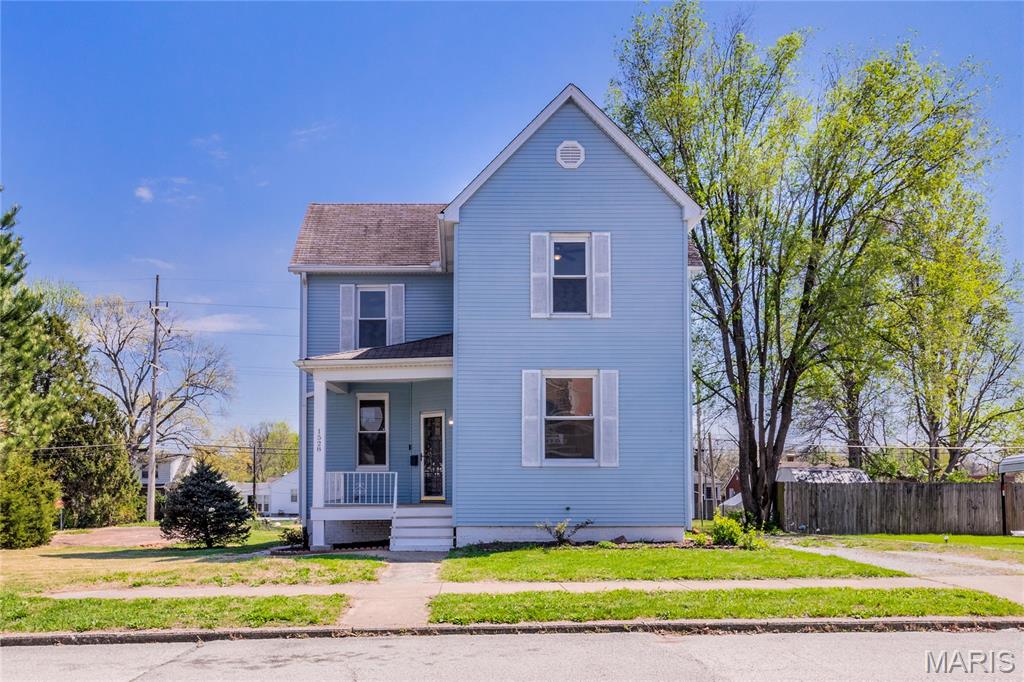 Built in 1904 this two story historic home has been updated with contemporary conveniences while keeping  its historic charm and architectural integrity intact! Luxury LVT, newer carpeting, pristinely tiled kitchen and baths, freshly painted surfaces throughout plus beautiful kitchen and bathroom updates! This move in ready home offers tons of living and storage space on two city lots in Belleville Illinois! Main floor primary bedroom with abundant double closet space and more bedrooms upstairs. You have flexible choices on room classifications, formal dining room or den/library, main floor primary or home office! Tons of green lawn/garden opportunities with two large lots! A huge side yard patio plus a covered back porch presents alfresco dining, relaxing and entertaining space!  An added bonus are the solar panels that help keep utility bills at a minimum and a full lower level basement for laundry, storage and more HGTV finished living space projects! Don't miss this fabulous updated contemporary victorian!! Call your favorite realtor today for a private tour!