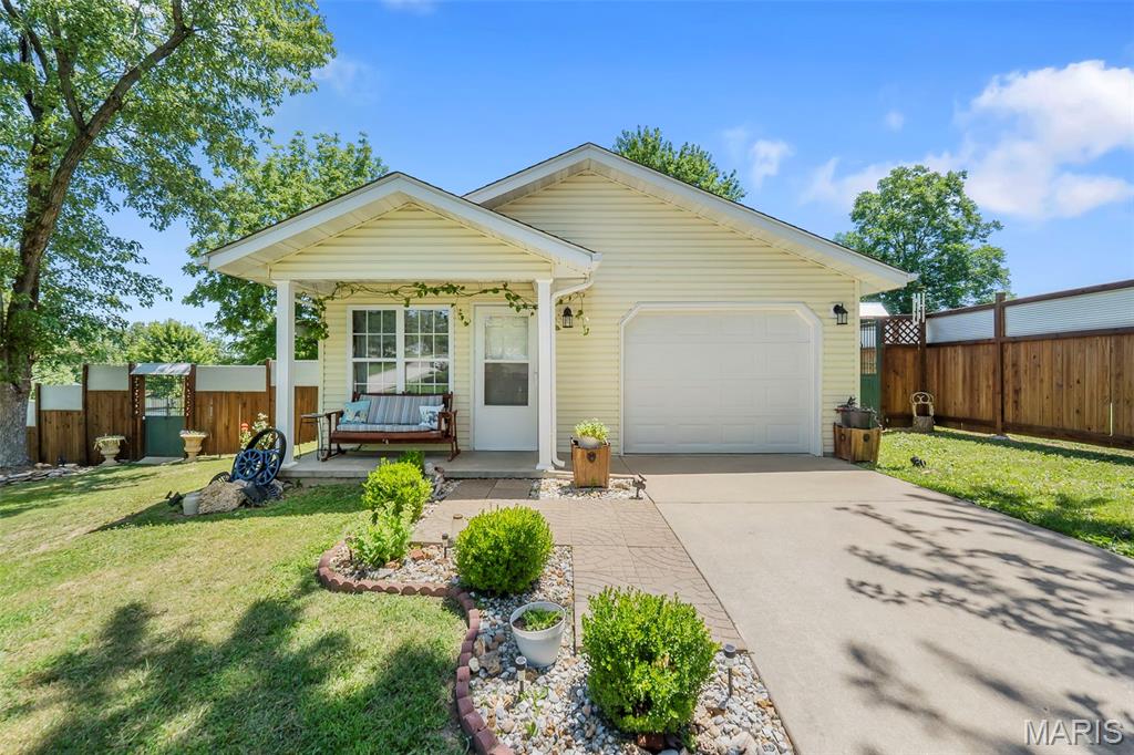 Looking to buy your first home, downsize, or retire comfortably? This charming 2 bed, 1 bath home offers nearly 1,000 sq ft of low-maintenance living on a beautifully landscaped corner lot. The home features updated paint, concrete floors and a comfortable interior.

Step outside to discover what truly makes this property special. The fully fenced yard showcases custom craftsmanship throughout, including handcrafted fencing, antique iron gates, mature landscaping, fruit trees, rose bushes, garden space, decorative fountains, and multiple outdoor gathering areas. A storage shed and extensive outdoor improvements make this property easy to enjoy from day one.