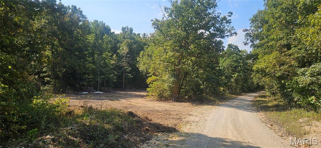 5.4 acre m/l in Indian Trails Subdivision with off the grid single wide mobile home.  Home is turn-key offering a propane stove, refrigerator, pantry and hot water heater. Bedroom furniture of bed and dresser. Kitchen table and chairs.  Two recliners. A 1500 gallon water tank and sewage lagoon on site for kitchen and bathroom use.  Heated with free standing wood stove and cooled with window unit.  Includes generator for power.  Just down the road from the Short Bend Access on the Meremac River, connected to 1000's of acres of Indian Trails Conservation area.  Come for the weekend, hunting season or live year round off the grid.  Being sold As Is.