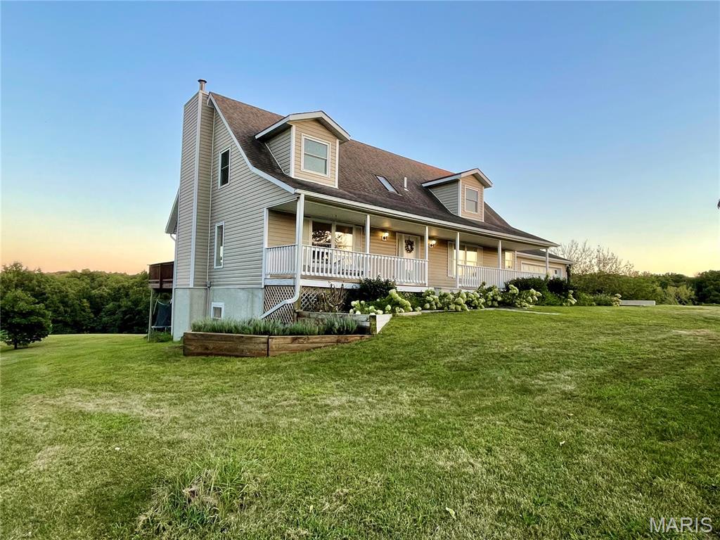Residential property located on approximately 9 acres short distance to Milan, Missouri, offering a remodeled home with multiple living areas and flexible use of space. The residence contains 4 bedrooms and 3.5 bathrooms across approximately 3,360 sq ft, with updates throughout including luxury vinyl plank flooring, plank-style ceilings, and refreshed interior finishes. The kitchen includes a propane range, stainless steel appliances, Spanish tile backsplash, ample cabinetry, and under-sink water filtration system. Main-level living areas provide functional separation while maintaining an open layout, with access to an elevated deck overlooking the surrounding property. The primary bedroom is located on the main level, with additional bedrooms and open-use space on the upper floor. The finished lower-level basement with exterior access includes a living area, kitchenette, bedroom, and bathroom, offering additional usable square footage for a variety of household needs. Exterior features include a mix of open ground and wooded areas, established fruit trees, and privacy from neighboring properties. The location provides short distance access to recreational land including the Roy Blunt Reservoir and Locust Creek Conservation Area. Fiber optic internet is available.
