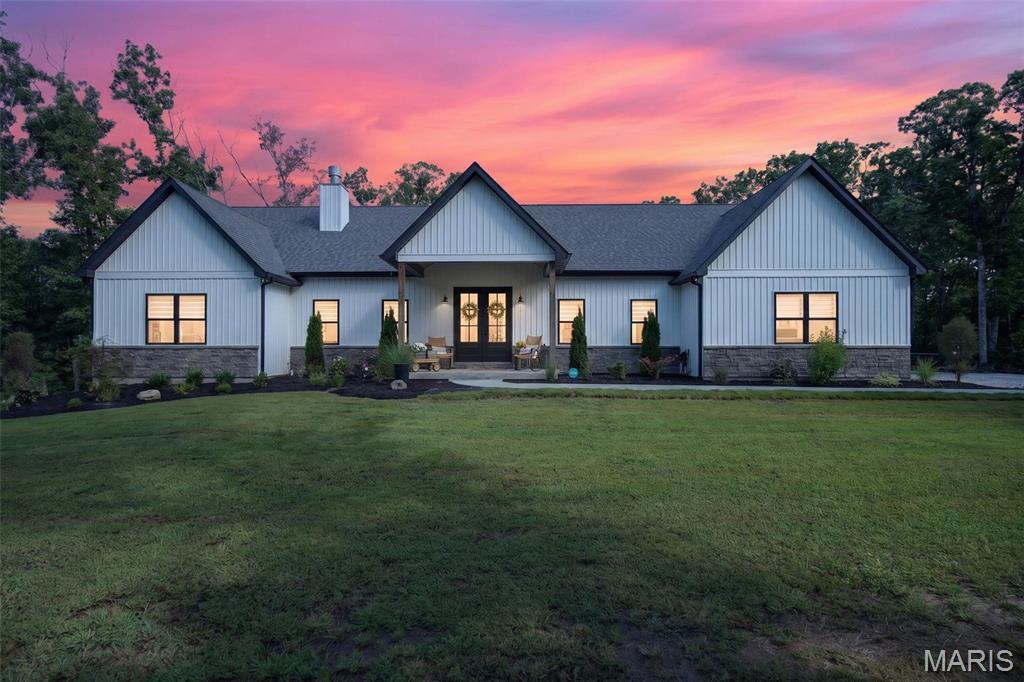 Welcome to 265 Whitetail, where privacy, space, and incredible outdoor living come together on more than 30 wooded acres just minutes from Warrenton and I-70. Built in 2022, this 5-bedroom, 4.5-bath home offers 2,418 sq. ft. on the main level plus approximately 200 sq. ft. finished in the lower level. The split-bedroom floor plan features a private primary suite with a luxury bath on one side and three additional main-level bedrooms with two baths, including a Jack-and-Jill, on the other. The heart of the home offers 11' ceilings, a large center island, walk-in pantry, wood-burning fireplace, and an open layout made for gathering. You'll also find main-floor laundry, a mudroom area, half bath, and an oversized finished and insulated 34' x 30' garage. Downstairs, a fifth bedroom and full bath are already finished, geothermal, heating And cooling, while the 9' basement pour provides plenty of room for future expansion. Outside is where this property really shines. Step from the main living area onto the covered patio with a second wood-burning fireplace, then out to the L-shaped inground pool, covered pool bar/lounge area, and expansive concrete patio with plenty of room to relax and entertain. Beyond the pool are 30+ mostly wooded acres offering exceptional privacy, a creek, deer stand, and room to enjoy the outdoors or hunt! Nearly new construction, acreage, a pool, and an incredible entertaining setup—all within minutes of town. Showings start on Wednesday, September 2.