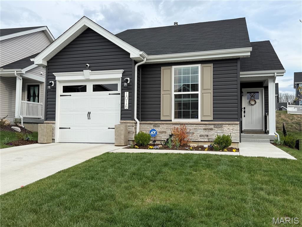 Enjoy modern living in this newer, well-appointed 2-bedroom, 2-bath home located in a peaceful community with easy access to the metropolitan area. The open floor plan is highlighted by a vaulted ceiling in the living room, creating a bright and spacious atmosphere, while additional windows and sliding glass doors flood the space with natural light. The kitchen features 42” soft-close cabinets and drawers, quartz countertops, and stainless-steel appliances. The primary bedroom offers a private en suite bath and walk-in closet, while a second bedroom and additional full bath provide added conveniences. Main-floor laundry includes the washer and dryer, which stay with the home. Unlike standard builder-grade models, this home has many upgrades including two-panel interior doors, Craftsman-style garage door, luxury vinyl plank flooring throughout, and integrated smart home technology with keypad entry and a smart thermostat. Additional value is found in the whole-house Watts Pure Water Softener installed in 2025 and a full basement with an egress window and full bathroom rough-in - massive potential for future living space. Nestled in a beautiful community with gentle hills perfect for both leisurely strolls and challenging runs, this move-in-ready home offers many aspects of a custom-build without the wait or the added expense.