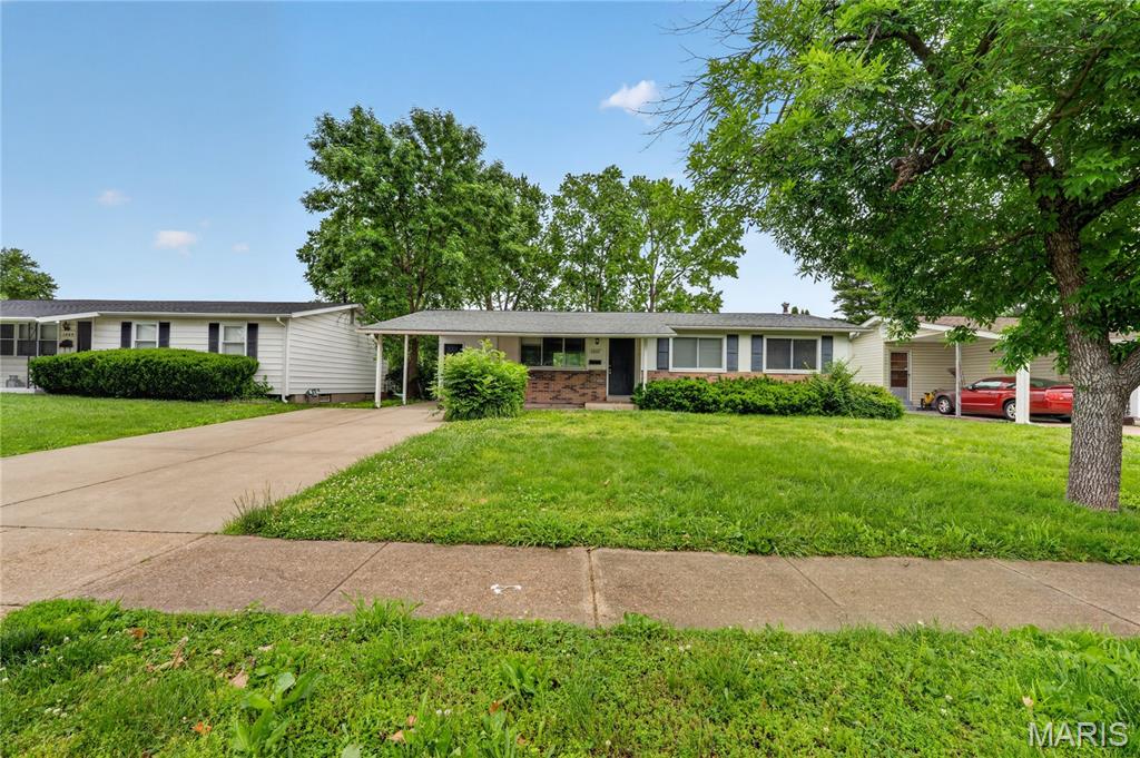 Welcome to this charming 3-bedroom, 1.5-bath ranch nestled in the heart of Florissant! Spanning 1,078 sq. ft. of thoughtfully maintained living space, this 1963 classic offers the perfect blend of mid-century character and modern updates. Step inside to find gleaming hardwood floors that flow through the sun-drenched living area and separate dining room. The kitchen is ready for your culinary touch, offering a functional layout that overlooks the level, fenced backyard—ideal for summer BBQs and pets.

The three spacious bedrooms provide ample comfort, while the full basement offers incredible potential for additional living space, a home gym, or a workshop. Recent upgrades, including newer windows and central cooling, ensure year-round efficiency. Outside, a convenient covered carport protects your vehicle from the elements. Located just minutes from parks, shopping, and major highways, this home is part of the desirable Hazelwood School District.
