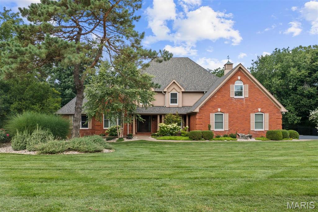 Welcome to this exquisitely renovated home in the heart of Town & Country, where every detail has been thoughtfully designed and no expense has been spared. From the moment you step into the dramatic two-story foyer with gleaming oak hardwood floors, you'll appreciate the exceptional craftsmanship and timeless elegance throughout. The stunning two-story great room features soaring beamed cathedral ceilings and a floor-to-ceiling brick fireplace with gas logs, creating a warm yet impressive gathering space. Just beyond, the chef's kitchen is designed for everyday living and entertaining, offering a large center island, quartz countertops with a full-height backsplash, premium stainless-steel appliances, and an adjoining breakfast room. Both the kitchen and great room open seamlessly to an expansive composite deck with a retractable awning overlooking the resort-style backyard. The luxurious main-floor primary suite is a private retreat featuring a spa-inspired bathroom with heated floors, dual vanities, a freestanding soaking tub, and an oversized walk-in shower with dual shower heads. A custom walk-in closet provides exceptional storage, while direct access to the adjoining office with custom built-ins creates the perfect work-from-home space. A spacious laundry room with abundant storage and an updated powder room complete the main level. Upstairs, you'll find three generously sized bedrooms, each with a custom walk-in closet. One bedroom offers a private en-suite bath, while the remaining two share a beautifully appointed Jack-and-Jill bathroom. A large bonus room provides endless flexibility as a playroom, fitness room, media space, or hobby room. The fully finished lower level expands the home's exceptional living space with a kitchenette, a media room featuring a fireplace, a game room, an exercise room, a full bathroom, and a secure vault. The backyard is truly a showpiece, designed for year-round entertaining with a spectacular pool, a fully equipped outdoor kitchen, a gazebo, a fire pit, an integrated speaker system, and extensive professional landscape lighting. Additional highlights include an oversized three-car garage with epoxy floors, expansive walk-up attic storage, newer Pella windows and doors throughout, a whole-house generator, three-zone HVAC, three water heaters, a four-year-old roof, and a brand-new asphalt driveway. Offering an unmatched combination of luxury, comfort, and thoughtful updates, this extraordinary home is completely move-in ready and truly one of a kind.