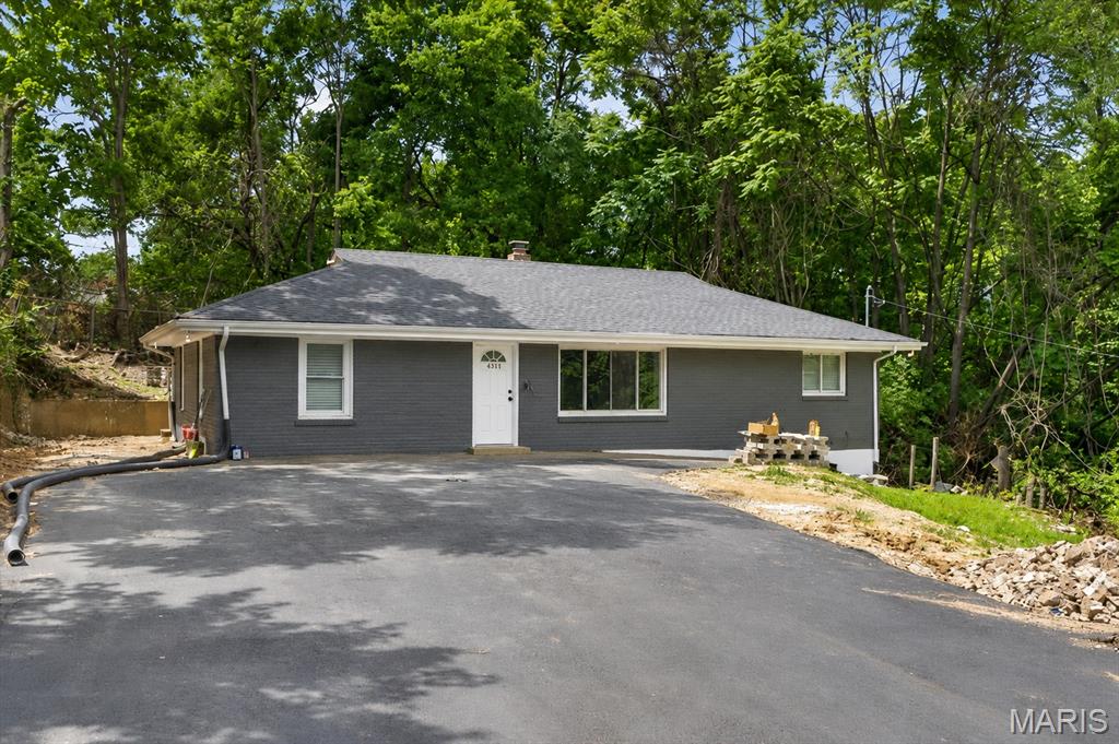 Welcome home to this private, FULLY UPDATED, large, brick ranch home! This home has been transformed from the ground up! Walk into a large open floor plan with a family room, dining room, large kitchen, 3 bedrooms and one full bath on the main level. Downstairs you will enjoy more living space, a bonus room and another full bath. The updates in this home include HVAC 2024, new roof & hot water heater 2025, ALL new electric- new service, panel & wiring, new plumbing throughout - including new sewer line under the home, new windows all in 2026. There is no shortage of parking, there is enough for 8+ cars! This is a must see, schedule your showing today!