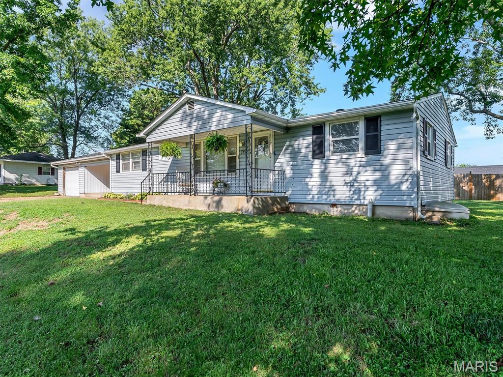 MOTIVATED SELLER! - Brand New Roof in 2026!  Welcome home to this comfortable 4-bedroom, 2-bath MOVE-IN READY HOME conveniently located within walking distance of schools and the city park. Inside, a vaulted ceiling creates an open, inviting atmosphere, while new flooring throughout, six-panel doors, and a decorative fireplace add comfort and character. The kitchen comes complete with stainless steel appliances and walks out to the laundry room, where the washer and dryer are also included.

The primary suite offers a private full bathroom and a generous walk-in closet. Outside, enjoy a fenced-in patio area for pets and entertaining, and a HUGE side yard (2.5 city lots total) with plenty of room for play. An attached garage and attached carport provide ample covered parking, while the new roof and encapsulated crawl space with a sump pump and backup sump pump add valuable peace of mind. With its flexible living space, thoughtful updates, and convenient location, this home is ready for its next owner!