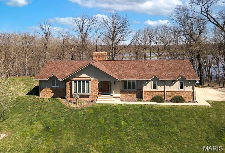 COUNTRY LIVING.  Look no further than this custom 3 bed/3 bath ranch in the Clinton Bluffs Subdivision north of Breese.  There are custom Markus cabinets throughout the house.  The open concept kitchen/dining room/great room provides a perfect area for entertaining.  Sunken great room has a beautiful wood-burning fireplace with a cathedral ceiling.  Main level consists of a breakfast room, master bedroom suite, 2 other bedrooms & a full bathroom.  Lower level has a family room with a wood-burning fireplace, full bathroom, large laundry room, office area, 2 bonus rooms & a storage area.  The house has a walk-out basement with a large composite deck on the main level and a stamped concrete patio on the lower level.   The home sits on .84 acres and is located mins from St. Joseph’s Hospital and Rt 50.  Don’t miss your chance to own this beautiful home and enjoy the peace and tranquility of country living.