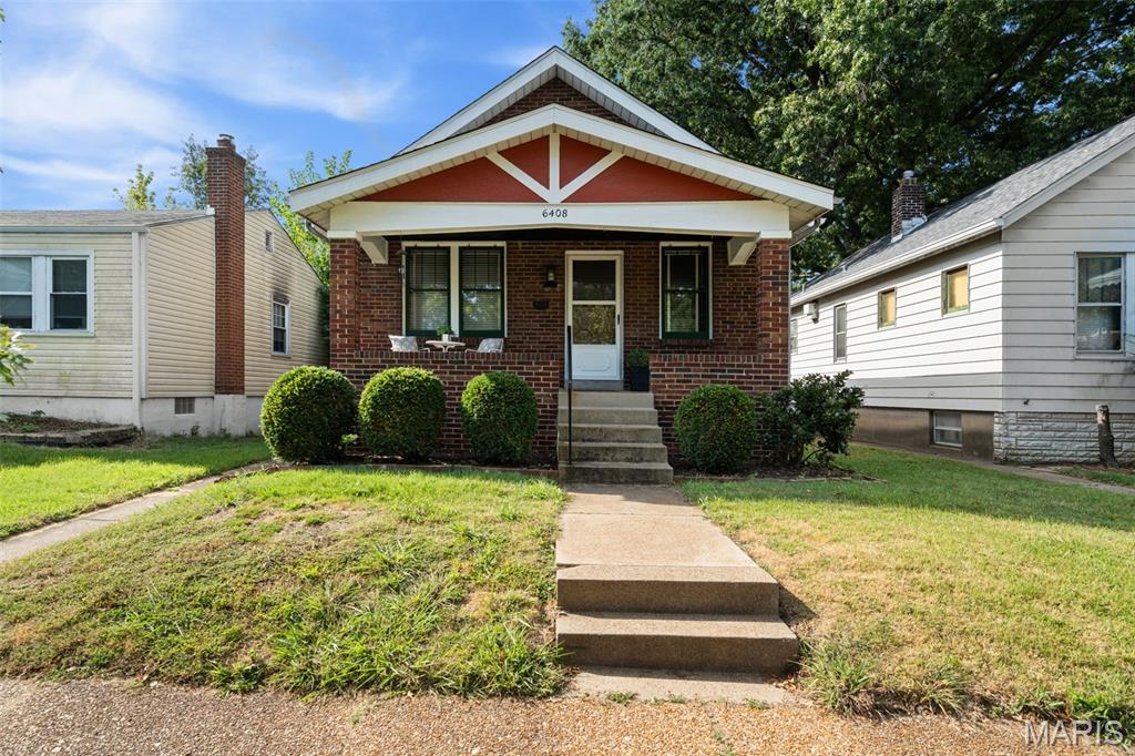 This all-brick bungalow is as charming as it gets! Stained-glass windows, hardwood floors, beautiful original woodwork - it is everything you have been dreaming of.  The inviting covered front porch leads into a spacious living room and formal dining room, perfect for entertaining. The updated kitchen features abundant cabinet storage and opens to a huge bonus room offering endless versatility. The full bath features a new vanity and a linen closet.  Don't forget to take a peek at the attic space - it is just waiting for someone to tap into all the potential up there!  The unfinished, walk-out basement has laundry hookup and more potential for additional living space. The detached garage is a fantastic added bonus for city living! Close to parks, restaurants, shops and public transportation.