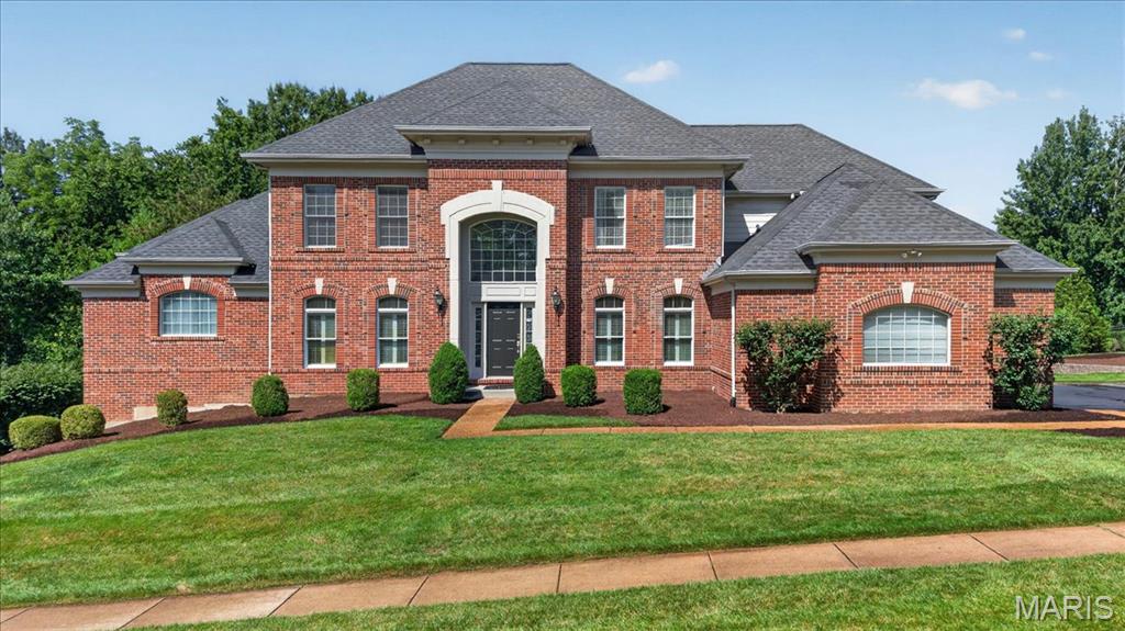Step into a palace-like setting in the coveted Wildhorse Creek Corridor. At 343 Pine Bend, impressive architecture and everyday living come together. A full brick front, curved statement staircase, soaring 20+ foot wall of windows, and extensive millwork throughout create an unforgettable first impression. This 1.5-story home offers 5 bedrooms, 6 bathrooms, and over 5,500 square feet of living space. The open floor plan features a formal dining room, private office/den, and a kitchen with granite countertops that flows seamlessly into the hearth room. Three fireplaces add warmth and character throughout the home. The spacious main-floor primary suite features coffered ceilings, a bay window, a large walk-in closet, and a private bath. Upstairs you'll find three spacious bedrooms, each bedroom including a private ensuite, and all with walk-in closets. Natural light pours into every corner of the home. Outside, the flat, usable 0.6-acre lot offers endless possibilities and is serviced by a full irrigation system to keep the yard looking its best. There's plenty of room for a pool, or set up two soccer goals and bring the World Cup to your own backyard. A large deck and covered patio provide the perfect space for entertaining, while the oversized 3-car garage offers plenty of room for vehicles, storage, and hobbies. The finished lower level is ideal for entertaining, hosting guests, or multigenerational living, featuring a full kitchen, custom stone fireplace, spacious bedroom, full bath, workout room, movie room, and exceptional storage with two storage rooms and a custom shelving closet. Located in the award-winning Rockwood School District, just minutes from Chesterfield Valley and Highway 40/64, this home truly has it all.