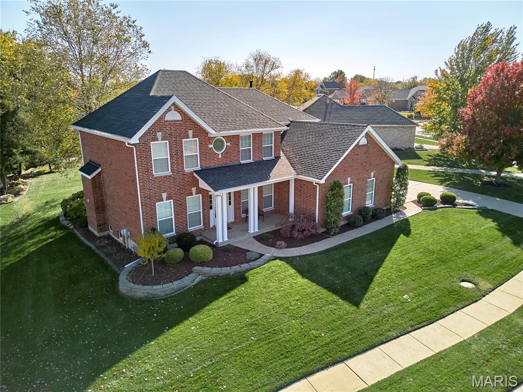 Overlooking the 5th green of Bear Creek Golf Course, this exquisite all-brick two-story home offers timeless elegance, exceptional curb appeal, and a truly move-in-ready experience. Meticulously maintained and nestled within one of the area’s most sought-after golf communities, this residence delivers both luxury and comfort. Inside discover refined living spaces designed for both entertaining and everyday living. A sophisticated formal dining room sets the stage for memorable gatherings, while a versatile front living room easily transforms into a stylish home office. The heart of the home is the inviting family room, anchored by a cozy gas fireplace and seamlessly connected to the gourmet kitchen. Here, you’ll find 42” cabinetry, granite countertops, stainless steel appliances, and a spacious eat-in area with serene views of the lush, level backyard, perfect for effortless indoor-outdoor living. Upstairs, retreat to the tranquil primary suite featuring two walk-in closets and a spa-inspired ensuite with dual vanities, a soaking tub, and a separate shower. Three generously sized additional bedrooms all include walk-in closets; two share a Jack-and-Jill bath, while the fourth enjoys its own full bath ideal for guests or multigenerational living. The finished lower level adds even more versatility with a recreation room and abundant storage. Enjoy resort-style amenities including the community pool, or enjoy a round of golf just beyond your backyard. Conveniently located minutes from shopping, dining, and everyday necessities, with quick access to Highways 70 and 64, this home perfectly blends elegance, functionality, and an unbeatable location.