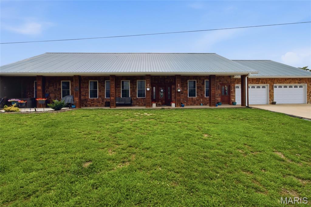 :Welcome to 16705 Oakhill Drive, a spacious and energy-efficient Earthberm home situated on 3.78 acres just outside the city limits. This unique 4-bedroom, 4-bathroom home offers the perfect blend of comfort, functionality, and country living. The home's attractive exterior features a rock front, vinyl siding on the sides and rear, and a durable metal roof. Inside, you'll find two exceptionally large main-floor bedrooms, each with its own private bathroom, providing comfort and privacy for family members or guests. The main floor also includes a convenient laundry area. Upstairs are two additional bedrooms, one of which is non-conforming, along with a full bathroom and a spacious family room or playroom, offering flexible living space for a variety of needs. The heart of the home is the expansive kitchen and dining area, highlighted by custom hickory cabinetry, a large island with quartz countertop, and plenty of room for gathering and entertaining. Cozy gas fireplaces in both the dining room and living room create a warm and inviting atmosphere throughout the year. Additional versatile spaces include an office or workout room located off the kitchen and a mudroom with electrical hookups ready for a tanning bed, conveniently situated between the home and the attached 3-car garage Built with spray foam insulation, this home is designed for energy efficiency while providing abundant storage throughout. Outside, the covered front porch and patio area offer the perfect setting to entertain guests, enjoy peaceful evenings, or relax with family while taking in the surrounding acreage