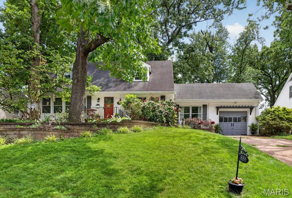 Tucked away at the back of a sought-after neighborhood, this charming Cape Cod offers the perfect blend of privacy, character, and convenience. Situated on a beautiful 1/3-acre lot, the home backs to a serene setting with mature trees and a flat, private backyard that feels like a peaceful retreat—almost as if you're camping in the woods—yet you're just minutes from Webster Groves, Kirkwood, shopping, dining, and everyday amenities. Built in 1950 and solidly constructed, this 3-bedroom, 2-bath home showcases an impressive amount of custom craftsmanship throughout its 2,692 square feet. The stunning custom-designed kitchen features handcrafted cabinetry, a custom shiplap ceiling, abundant workspace, and an open kitchen/dining area perfect for gathering with family and friends. The brand-new bathrooms have been beautifully renovated with exceptional attention to detail. The spacious living room is filled with natural light from large windows and offers gorgeous built-ins, hardwood floors, and timeless character. On the main level, you'll find a bedroom retreat complete with two custom closets, while an additional side room (off of kitchen) with its own unique stepped-down entry adds charm and flexibility for a home office, reading nook, or playroom. Additional highlights include a walk-out partially finished basement, hardwood flooring throughout, an adorable staircase, abundant natural light, and a floor plan that offers both functionality and warmth. Outdoor enthusiasts will love the proximity to Grant's Trail and the three neighborhood parks, while families will appreciate the award-winning Lindbergh School District and the strong sense of community that makes this neighborhood so special. Quiet, private, beautifully updated, and full of character—this is a home that must be experienced to be truly appreciated.