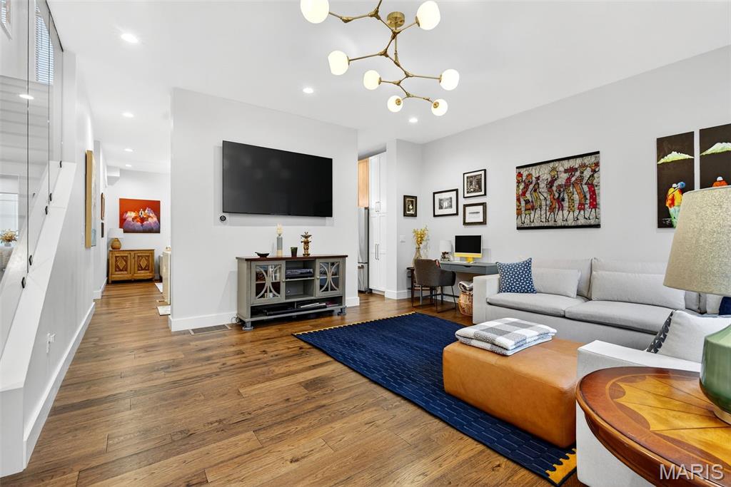 Welcome to the Artizen on West Pine Townhomes — where modern design, chic style, and effortless city living come together. Built in 2023, this contemporary townhouse showcases soaring ceilings, wide-plank wood flooring, expansive picture windows that flood the home with natural light, and high-end designer finishes throughout. The spacious formal living room welcomes you in and flows seamlessly into a stunning chef’s kitchen featuring sleek cabinetry, an upgraded tile backsplash, an oversized quartz island, and top-tier stainless steel appliances. An additional open living area just beyond the kitchen provides the perfect flexible space for lounging, entertaining, or creating your ideal setup. Upstairs, the primary suite impresses with its generous walk-in closet, a spa-inspired bathroom with a floating dual-sink vanity and glass shower, and a private balcony — your perfect spot for morning coffee or evening wind-downs. A secondary bedroom with a custom walk-in closet, a full bath with a tub/shower combo, and a dedicated laundry closet complete this level. The top floor is designed for entertaining, featuring a wet bar with a beverage fridge and a PRIVATE ROOFTOP TERRACE — an incredible urban oasis with room to gather, unwind, and take in the surroundings. The finished lower level adds even more versatility with an additional bedroom, full bathroom, and an oversized two-car garage with great storage options. The garage leads to a private, gated drive court shared by residents. With exceptional space, thoughtful design, and an unbeatable location, this townhouse offers the ultimate blend of luxury and vibrant city living. You also get a PRIVATE DOG PARK with this community located next to #13 (at the edge of the complex). All within walking distance to the Cortex, IKEA, BJC and the best of the Central West End and a short drive from SLU! 12 month minimum lease, $45 app fee per adult. Available early September.