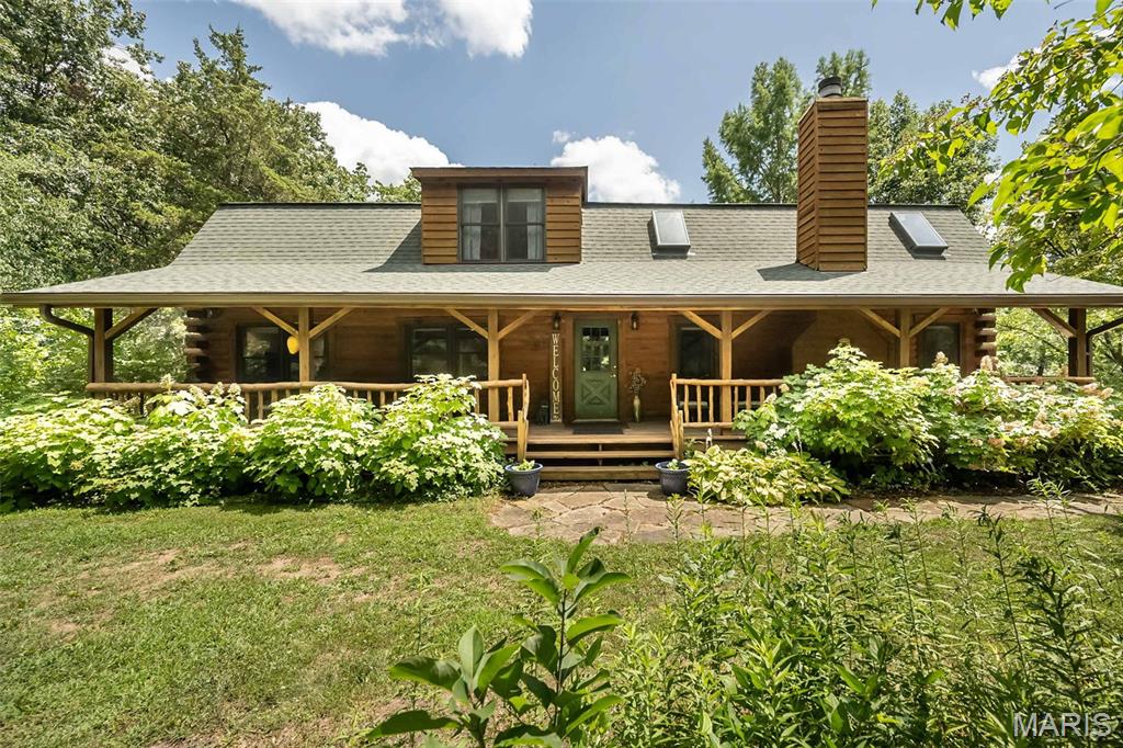 Escape to your own private retreat with this stunning log home nestled on 3 picturesque acres, where peaceful country living meets modern comfort. Surrounded by mature trees and breathtaking natural beauty, you'll enjoy the serenity of nature while remaining just 15 minutes from Highway 40, offering the perfect balance of privacy and convenience. Enjoy the view from either the fully covered front deck or fully covered back deck!

Inside, this spacious 4-bedroom, 3.5-bath home welcomes you with a dramatic two-story great room, soaring ceilings, a striking floor-to-ceiling stone fireplace, and an open loft overlooking the living space below. Warm bamboo flooring flows throughout the main level, complementing the rustic charm with updated finishes.

The beautifully renovated kitchen is the heart of the home, featuring quartz countertops, 42-inch cabinetry, a custom tile backsplash, and updated appliances, making it as functional as it is beautiful. The thoughtfully redesigned floor plan includes a convenient main-floor laundry room, along with two bedrooms on the main level. Upstairs, you'll find a private primary suite and an additional bedroom with its own en-suite bath, offering flexible living arrangements for family or guests.

This home has been meticulously maintained with significant updates, including:

2019: Extensive main-floor renovation with floor plan modifications, new hallway, added laundry room, and a completely updated kitchen.
2021: Full exterior professionally sandblasted and stained.
2022: New roof and added skylights that fill the great room with natural light.
2024: New septic system drain field and lift station, plus new garage doors.
2025: Brand-new HVAC system.

Whether you're sipping coffee on the porch, enjoying evenings by the stone fireplace, or taking in the peaceful surroundings, this one-of-a-kind log home offers the lifestyle you've been dreaming of. If you've been searching for timeless character, modern updates, and room to breathe, this extraordinary property is one you won't want to miss.