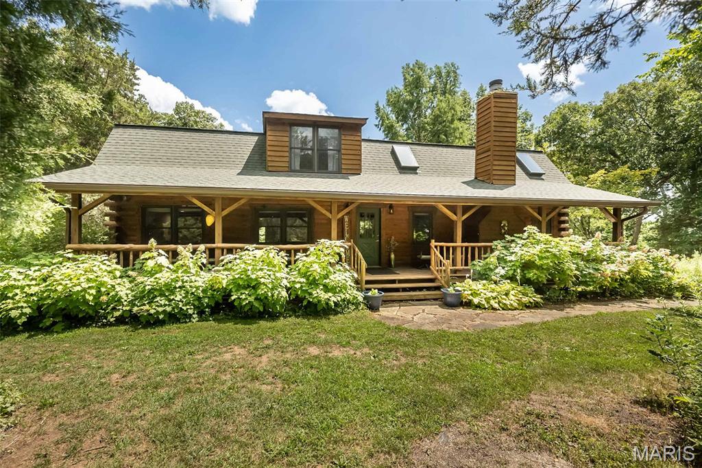 Escape to your own private retreat with this stunning log home nestled on 3 ACRES, where peaceful country living meets modern comfort. Surrounded by mature trees and breathtaking natural beauty, you'll enjoy the serenity of nature while remaining just 15 minutes from Highway 40 and Highway 70, offering the perfect balance of privacy and convenience. Enjoy the view from either the fully covered front deck or fully covered back deck!

Inside, this spacious 4-bedroom, 3.5-bath home welcomes you with a dramatic two-story great room, soaring ceilings, a striking floor-to-ceiling stone fireplace, and an open loft overlooking the living space below. Warm bamboo flooring flows throughout the main level, complementing the rustic charm with updated finishes.

The beautifully renovated kitchen is the heart of the home, featuring quartz countertops, 42-inch cabinetry, a custom tile backsplash, and updated appliances, making it as functional as it is beautiful. The thoughtfully redesigned floor plan includes a convenient main-floor laundry room, along with two bedrooms on the main level. Upstairs, you'll find a private primary suite and an additional bedroom with its own en-suite bath, offering flexible living arrangements for family or guests.

This home has been meticulously maintained with significant updates, including:

2019: Extensive main-floor renovation with floor plan modifications, new hallway, added laundry room, and a completely updated kitchen.
2021: Full exterior professionally sandblasted and stained.
2022: New roof and added skylights that fill the great room with natural light.
2024: New septic system drain field and lift station, plus new garage doors.
2025: Brand-new HVAC system.

Whether you're sipping coffee on the porch, enjoying evenings by the stone fireplace, or taking in the peaceful surroundings, this one-of-a-kind log home offers the lifestyle you've been dreaming of. If you've been searching for timeless character, modern updates, and room to breathe, this extraordinary property is one you won't want to miss.