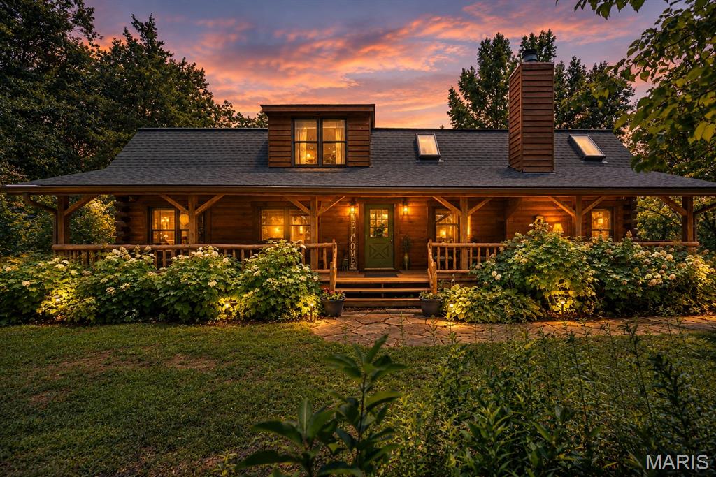 Escape to your own private retreat with this stunning log home nestled on 3 ACRES, where peaceful country living meets modern comfort. Surrounded by mature trees and breathtaking natural beauty, you'll enjoy the serenity of nature while remaining just 15 minutes from Highway 40 and Highway 70, offering the perfect balance of privacy and convenience. Enjoy the view from either the fully covered front deck or fully covered back deck!

Inside, this spacious 4-bedroom, 3.5-bath home welcomes you with a dramatic two-story great room, soaring ceilings, a striking floor-to-ceiling stone fireplace, and an open loft overlooking the living space below. Warm bamboo flooring flows throughout the main level, complementing the rustic charm with updated finishes.

The beautifully renovated kitchen is the heart of the home, featuring quartz countertops, 42-inch cabinetry, a custom tile backsplash, and updated appliances, making it as functional as it is beautiful. The thoughtfully redesigned floor plan includes a convenient main-floor laundry room, along with two bedrooms on the main level. Upstairs, you'll find a private primary suite and an additional bedroom with its own en-suite bath, offering flexible living arrangements for family or guests.

This home has been meticulously maintained with significant updates, including:

2019: Extensive main-floor renovation with floor plan modifications, new hallway, added laundry room, and a completely updated kitchen.
2021: Full exterior professionally sandblasted and stained.
2022: New roof and added skylights that fill the great room with natural light.
2024: New septic system drain field and lift station, plus new garage doors.
2025: Brand-new HVAC system.

Whether you're sipping coffee on the porch, enjoying evenings by the stone fireplace, or taking in the peaceful surroundings, this one-of-a-kind log home offers the lifestyle you've been dreaming of. If you've been searching for timeless character, modern updates, and room to breathe, this extraordinary property is one you won't want to miss.
