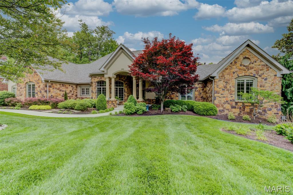 The dream, the vision, the plan, the view – the result is extraordinary! Nine months of planning and a year to build, this unique home is designed for relaxed living, fun and lively entertaining, and all the coziness of home. Strategically situated to maximize and enjoy natural, wooded views from most rooms, the Brazilian hardwood deck and screened porch. Entering the octagonal foyer is like a big hug, welcoming you to all this home has to offer. Notice 12’ ceilings in the LR, DR, and foyer, with 10’ ceilings elsewhere on the main level, 5-piece crown molding and multi-tiered lighting. Comfortable gathering area with great room, kitchen, breakfast room, breakfast bar with seating for 8, butler’s pantry and spirits bar, all with walnut flooring, custom handmade cabinetry and granite counters. Working kitchen is a cook’s delight with 6 burner Wolf gas cooktop, pot filler faucet, and double ovens. The primary suite offers private sitting room, built-in coffee bar/TV/storage, and expansive walk-in closet. Luxury bath has relaxing air tub (bubbles, not water jets!), walk-in shower, and individual vanities. 2nd bedroom with shared bath, dedicated home office and laundry room complete the main level. Beautifully finished LL features FR, dining area, full kitchen, 3 bedrooms, 2.5 baths, cedar closet and storage. Drive-by eye-catching appeal with brick and stone facade and lush landscaping. Attention to detail and lovingly maintained. Truly a dream come true!