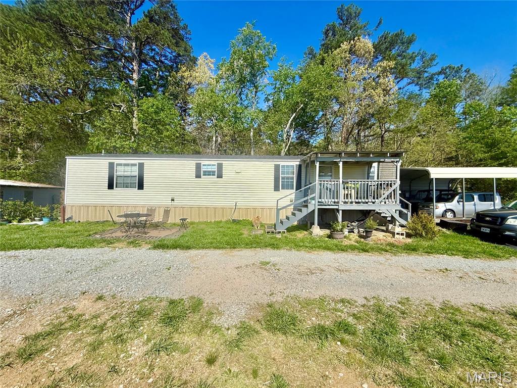 Welcome to your slice of peaceful country living! This 2009 single-wide home offers 2 bedrooms and 2 full bathrooms, perfectly situated on 5 acres of open pasture ground—ideal for anyone seeking space, privacy, and a touch of rural charm. Step inside to find a spacious living room that flows seamlessly into a bright, open kitchen featuring modern touches, updated appliances, and a brand-new refrigerator. Whether you’re entertaining guests or enjoying a quiet night in, this home offers a comfortable and functional layout designed for everyday living. The primary bedroom includes its own private full bathroom, providing a relaxing retreat at the end of the day, while the second bedroom and additional full bath offer flexibility for family, guests, or office space. Outside is where this property truly shines. The 5 acres of open pasture create endless opportunities for homesteading, hobby farming, gardening, or simply enjoying wide-open views. The land features fruit trees, including plum trees, adding both beauty and practicality to the property. A chicken coop and greenhouse are already in place, making it easy to start your own sustainable lifestyle right away. Additional highlights include a detached two-car carport to protect your vehicles from the elements,  and an oversized septic system. The property is serviced by a well and septic and is an all-electric home, offering added flexibility in utilities. The land has already been surveyed, giving you peace of mind and clarity for future plans. Enjoy your mornings and evenings from the front or rear porch, where every direction offers peaceful country views. The house is located just a short drive from Fredericktown, you’ll have the perfect balance of rural tranquility and convenient access to town amenities. All road leading to the property are paved allowing for easy access.  Whether you’re looking to start a homestead, invest in land, or simply enjoy country living, this property is full of opportunity and ready to welcome you home.
