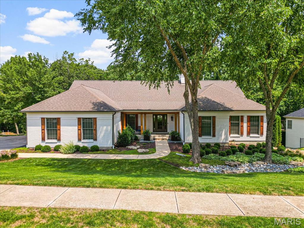 Welcome to a beautifully refined luxury ranch in The Villages of Wildhorse, ideally located near the heart of the Chesterfield Valley. Thoughtfully renovated and meticulously maintained, this home offers an exceptional blend of sophisticated finishes, comfortable living spaces, and resort-style outdoor living. A gracious entry with wood flooring, a custom front door, sidelights, and crown molding opens to an impressive great room where vaulted ceilings, custom built-ins, a dramatic wood-burning fireplace, and abundant natural light create an inviting focal point. The adjoining atrium brings even more character and light to the heart of the home, while the dining room provides an elegant setting for entertaining. The remodeled kitchen is both beautiful and functional, featuring custom 42" cabinetry, granite contertops, a redesigned center island, travertine tile, stainless appliances, double ovens, an electric cooktop, custom tile backsplash, and under-cabinet lighting. The kitchen flows effortlessly into the breakfast area and hearth room, creating a natural space for everyday living and gatherings. The hearth room adds another layer of warmth with its wood-burning fireplace, custom mantel, ceiling beams, plantation shutters, and Pella glass sliding doors that open to the outdoor living spaces. The spacious main-level primary suite is a peaceful retreat with vaulted ceilings, custom shutters, a ceiling fan, and a generous walk-in closet. Its beautifully updated bath features a large soaking tub, walk-in shower, double vanities, and transom windows that bring in natural light. Two additional main-level bedrooms and a full bath provide comfortable accommodations, while the finished lower level expands the living space with a large family room, wood-burning fireplace, wet bar, bedroom, office/additional bedroom, a full bath, and a pool locker room. Outdoor living is truly exceptional, centered around a gunite saltwater pool with an updated saltwater system, stone coping, expansive patio decking, and a fire pit. A custom cedar deck and beautifully designed landscaping create multiple places to relax and entertain, with the backyard thoughtfully enclosed by fencing and enhanced by upgraded irrigation and landscape lighting. The property also offers a finished 3-car side-entry garage. Extensive improvements over the years include major exterior renovations, HVAC updates, kitchen and interior renovations, custom landscape design, a new roof in 2026, and fresh interior paint in 2026. Located in a community offering pools, walking trails, lakes, and sports courts, this is more than a beautiful home, it is a lifestyle. A rare opportunity to enjoy the privacy and amenities of Wildhorse with the convenience of being just moments from everything the Chesterfield Valley has to offer.