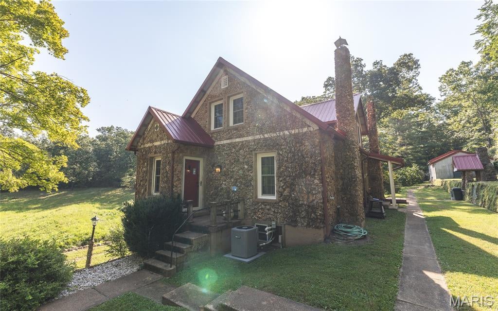 Escape to the heart of the Southern Ozarks with this beautiful 65-acre property located just outside Davisville, Missouri, and within approximately two hours of St. Louis. The property offers a peaceful setting with trickling creeks, natural springs, mature woods, and the timeless character of the Ozarks. At the heart of the property is a charming 1,400 sq. ft. stone cottage that has been completely remodeled and renewed while preserving its original character and historic charm. The 3-bedroom, 2-bath home features updated operating systems throughout, an updated kitchen, and tasteful improvements that blend modern comfort with the character of an older stone home. A durable metal roof adds to the home's long-term appeal. Historic stone walls and other antique stone features can be found throughout the property, adding a unique sense of history and character. An additional outbuilding provides convenient storage for equipment, tools, and everything needed to maintain the property. Whether you're looking for a private Ozark retreat, weekend getaway, or full-time residence, this 65-acre property offers a rare combination of natural beauty, historic charm, and modern updates in a peaceful Southern Missouri setting.