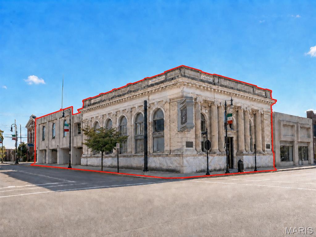 Rare opportunity to acquire a distinctive historic commercial property in the heart of downtown Collinsville. Located at 102 W. Main Street, this former bank building offers approximately 9,353 square feet of space across multiple sections and levels, providing exceptional flexibility for redevelopment, owner occupancy, investment, or a creative adaptive-reuse project.

The property showcases impressive architectural character throughout, including a prominent stone exterior, towering columns, arched windows, ornate ceilings, decorative millwork, a dramatic open atrium, mezzanine areas, and original bank vaults. The spacious interior features large open rooms, high ceilings, multiple stairways, reception and counter areas, and abundant natural light. A former drive-through canopy area is also included with the property.

The building is currently in varying stages of renovation and offers a substantial canvas for a buyer to complete according to their vision. Potential uses may include professional offices, event space, restaurant or hospitality concepts, retail, entertainment, mixed-use redevelopment, or other commercial possibilities, subject to zoning and governmental approval.

Positioned along Main Street near established businesses, dining, shopping, and community destinations, this highly visible property offers a unique combination of historic charm, architectural presence, and redevelopment potential. Property is being offered in its current condition. Square footage, dimensions, property condition, zoning, permitted uses, and all other information should be independently verified by the buyer.

Disclaimer: Some listing photographs may have been digitally enhanced to improve lighting, remove personal property or debris, and better illustrate the space. No structural alterations are intended to be represented.
