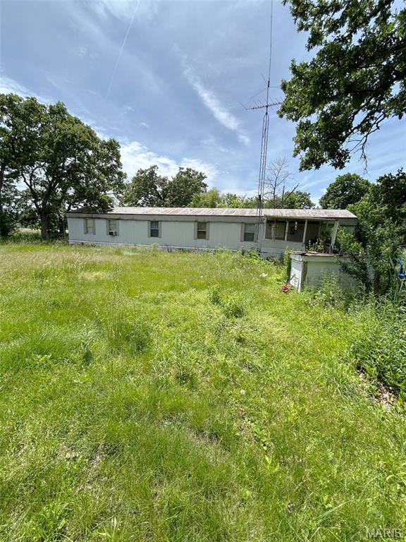Tucked away at the end of a gravel road, this 1.84 acre property offers the kind of privacy that's becoming increasingly difficult to find. The mobile home features a comfortable, livable interior and provides an affordable opportunity for full-time living, a weekend retreat, or a property to make your own over time.

The long, secluded parcel offers room for outdoor activities, gardening, hobby projects, or simply enjoying a peaceful setting away from traffic and neighbors. Several outbuildings provide additional storage space for tools, equipment, and recreational items.

The property is currently served by a deep well, lagoon, and leach field, with county water available nearby for future connection if desired. Whether you're looking for a private homestead, a recreational getaway, or an affordable country property with room to spread out, this one is worth a look.