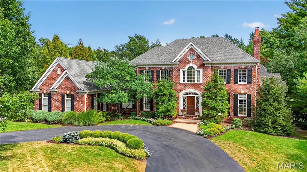 Stunning sophisticated expansive all brick home at the end of a cul-de-sac on a Frontenac private lane in the Ladue School District. Guests are welcomed through a grand entry highlighted by marble flooring and a 10-foot ceiling. The dramatic great room showcases soaring 14-foot ceilings and a striking custom-designed wall of windows that fills the home with natural light while framing picturesque views of the outdoor living spaces. A magnificent, oversized fireplace with marble surround and hearth is complemented by an elegant custom mantel featuring raised panel detailing and decorative sconces.
Throughout the main level, beautiful 4-inch select oak hardwood flooring, finished on-site, adds warmth and timeless elegance.
The gourmet kitchen is a showpiece, featuring marble countertops, a spacious center island topped with rich black walnut, and seamless flow into the inviting hearth room and breakfast area beneath a stunning crisscross box-beam ceiling. Elegant French doors open onto the expansive 530-square-foot covered veranda, thoughtfully designed for sophisticated outdoor living. With ample room for multiple seating and dining areas, this inviting retreat seamlessly extends the home's entertaining spaces while overlooking the private, resort-like backyard and picturesque landscape.
The luxurious primary suite offers a private retreat complete with a cozy box-bay sitting area and vaulted ceiling. 
The second floor includes three spacious ensuite bedrooms and a comfortable family room, providing ample space for family and guests.
The impressive walk-out lower level spans approximately 2,725 square feet and is designed for entertainment and relaxation. Amenities include a wine cellar, custom kitchen, billiards room, recreation room, media room, two additional bedrooms, and a full bath. French doors and expansive picture windows create a bright, inviting atmosphere while providing direct access to the outdoor living spaces.
Outside, the property feels like a private resort. A custom pool is surrounded by an expansive deck and beautifully landscaped grounds featuring colorful seasonal plantings, established greenery, and mature trees. A sprawling lawn and peaceful park-like setting complete this extraordinary estate, offering a rare combination of luxury, privacy, and natural beauty.
A truly exceptional home designed for refined living, grand entertaining, and everyday comfort.