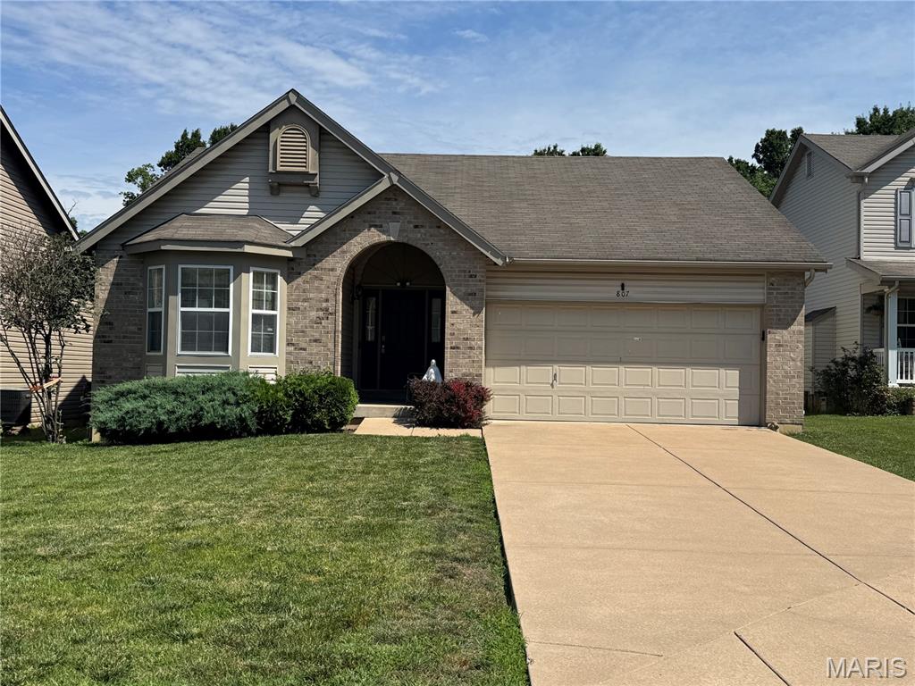 Welcome home to this spacious ranch nestled on a beautiful level lot that backs to common ground and mature trees, offering privacy and a peaceful setting to enjoy year-round. The attractive brick façade provides timeless curb appeal, while the vaulted ceilings and open floor plan create an inviting atmosphere filled with natural light.

The main level features three bedrooms and two full bathrooms, creating a comfortable and functional layout for everyday living. The finished lower level offers exceptional versatility with a large recreation room, a full second kitchen, a full bath, and a workshop—perfect for entertaining, extended family, guests, or hobby space.

While the home is in need of cosmetic updates, several important improvements have already been completed, including a newer HVAC system and an updated water heater. Paint and flooring updates are needed and provide an excellent opportunity for the next owner to add their personal touch. The roof is at the end of its expected service life.

The property is being sold "as is" and has been priced accordingly, presenting an excellent opportunity to build equity while enjoying a fantastic floor plan, a desirable tree-lined setting, and a sought-after O'Fallon location. Seller prefers to sell the property with all contents remaining in the home.