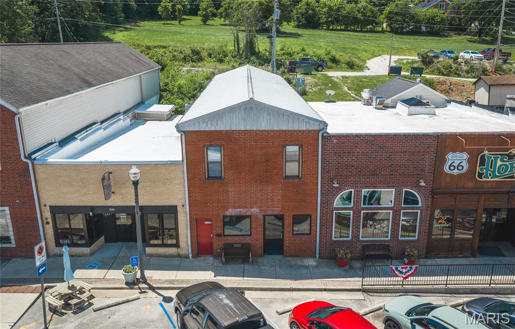 Don’t miss this rare opportunity to own a piece of history while creating your future on one of America’s most iconic highways—Historic Route 66! Ideally located in the heart of Waynesville, this landmark commercial property offers exceptional visibility, convenient access, and endless possibilities for entrepreneurs, investors, and business owners seeking a unique opportunity in a thriving area. Positioned along the famous Route 66 corridor with strong traffic exposure, this property benefits from year-round visibility from local residents, travelers, and the steady flow of military traffic from nearby Fort Leonard Wood. With its prime location, ample parking, and flexible layout, this building provides the perfect foundation for various business ventures while also offering built-in income-producing potential. Step inside to discover a front reception area designed to greet clients and customers, along with four spacious private offices that provide plenty of room for a professional workspace, multiple businesses, or a growing company. A conveniently located bathroom completes the main level. The current layout makes this property an excellent fit for attorneys, insurance companies, financial services, boutiques, salons, restaurants, retail concepts, or investors looking to add a valuable commercial asset to their portfolio. The opportunity continues upstairs, where you’ll find two separate apartment spaces, each featuring its own kitchen area and bathroom. These units offer incredible flexibility and can be utilized for short-term rentals, long-term tenants, employee housing, additional office space, or supplemental rental income. Combining commercial operations with residential income creates a unique advantage. Whether you envision restoring its legacy as a professional office, creating a destination business that captures the charm of Historic Route 66, opening a restaurant or retail concept, or maximizing the income potential as an investment property—the possibilities are truly endless. Surrounded by local attractions, community growth, and the constant activity of travelers passing through the area, this property offers the perfect blend of history, location, visibility, and opportunity. Own a piece of Route 66 history and turn your vision into reality! Properties like this don’t come available often—schedule your private showing today and explore the possibilities.