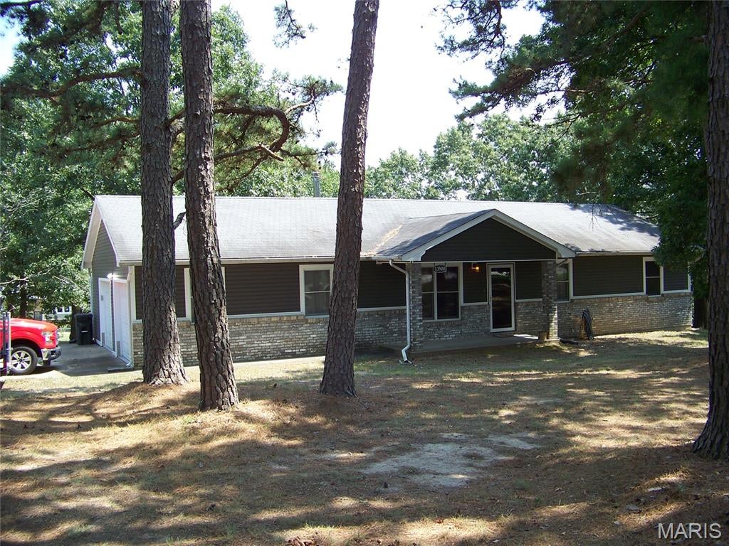 Lovely 3 bedroom, 2 bath on 1.04 acres m/l.  Don't wait to see this lovely home in the Timbers subdivision on almost level lot. Great location for all. Spacious living room with wood burning stove to save on utilities. Galley kitchen offers newer black appliances and plenty of wood cabinets and counter space. Breakfast area that walks out to screened in porch for lovely evenings with no pesky bugs and a space is available for a hot tub. 3 large bedrooms - all with laminate flooring. The master suite has a bathroom with walk-in shower. Main bath has also been updated with walk-in shower. You will like having a utility room and a full house water softener.  Also 2 car garage with plenty of storage or work area. Included is a 24 x 12 shed that will be outstanding for storage and is dry.