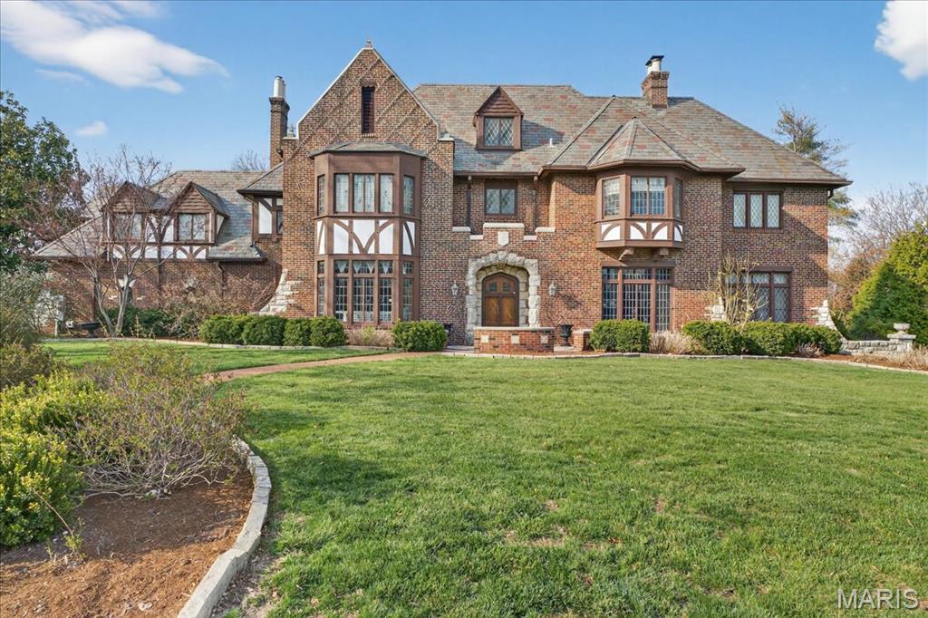 New Price, New Possibilites!! 
Nestled in the center of Lake Forest subdivision and commanding one of its most expansive sites, this distinguished brick and limestone Tudor estate is a rare blend of privacy, architecture, and curated outdoor living—framed by mature trees, a saltwater pool, a firepit lounge, and an elegant pergola retreat.

Inside, dramatic, light-filled spaces are rich with architectural character, featuring the finest building materials, soaring ceilings, meticulous leaded and stained glass windows, limestone fireplaces, and imposing chandeliers. The designer kitchen is both refined and functional, offering designer appliances, a center island, walk-in pantry, and a built-in breakfast banquette.

Upstairs, six bedrooms and four full baths provide generous, thoughtfully designed living spaces. A walk-up third floor attic offers exceptional storage or the opportunity for future expansion.

The luxury finished lower level is a lovely extension on the home featuring a charming second family room with the original stone fireplace and leaded glass windows, an exercise room, powder room and an abundance of storage.  
A three-car garage provides direct kitchen access and opens to additional parking and beautifully manicured grounds.

Recent enhancements—including a slate roof (2005), A/C units (2024, 2025), boiler (2006), plumbing, electrical, whole house tuckpointing (2010), and aggregate driveway—complete this timeless and impeccably maintained estate.